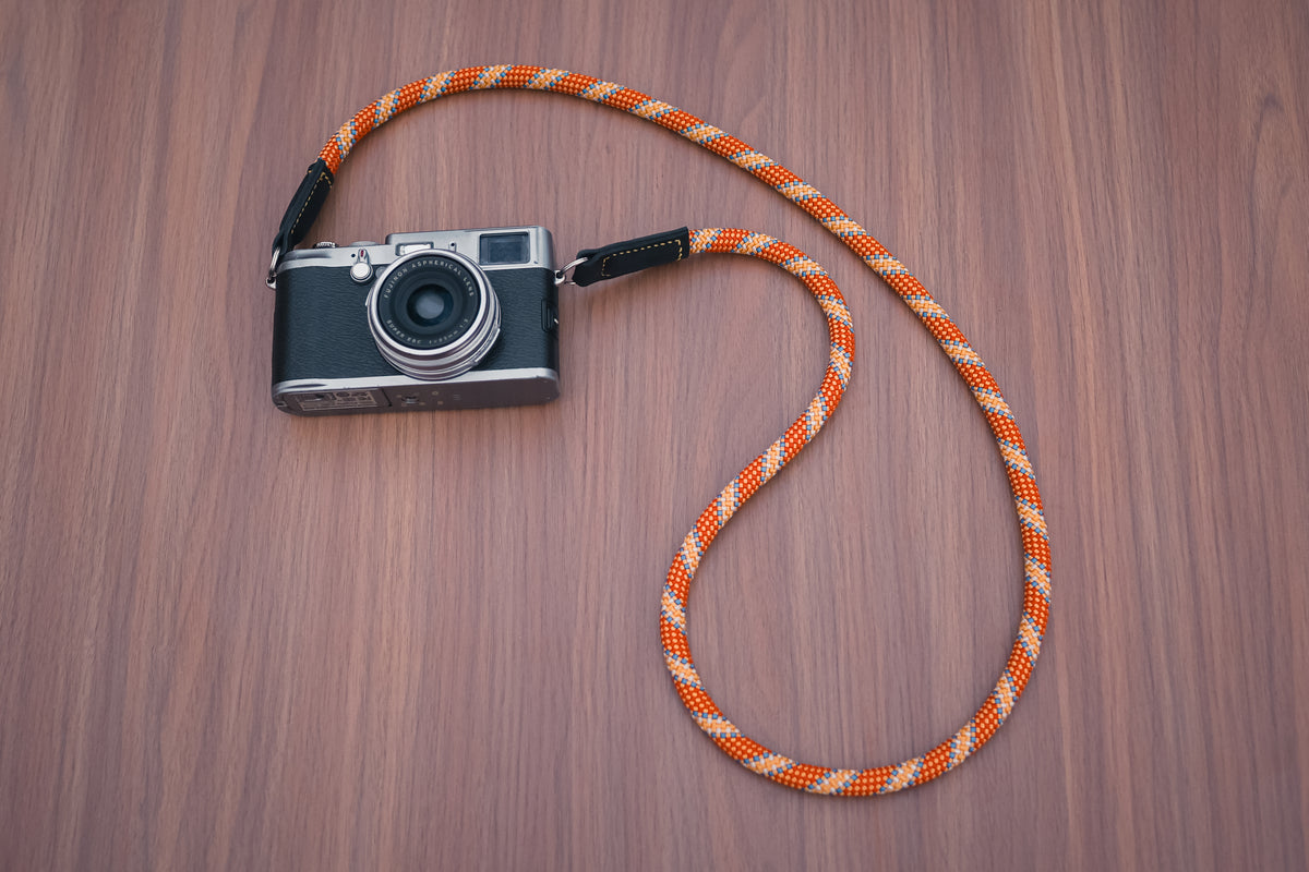 Handmade Windmup orange rope camera strap with golden accents