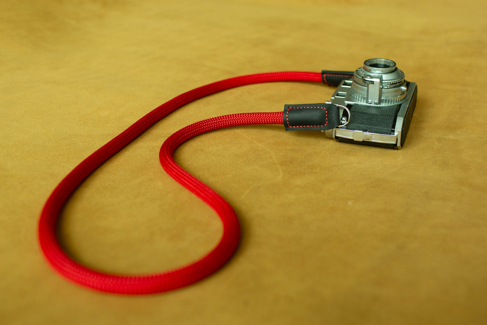 Handmade red climbing rope camera strap with premium leather ends by Windmup