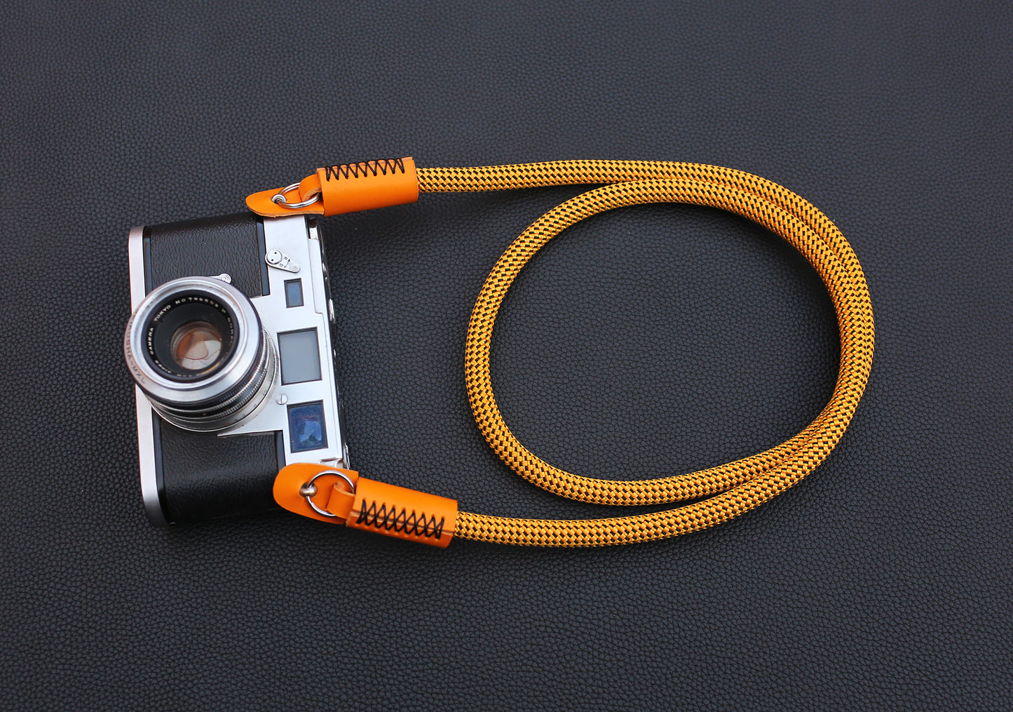Handmade rope camera strap with clean orange leather ends