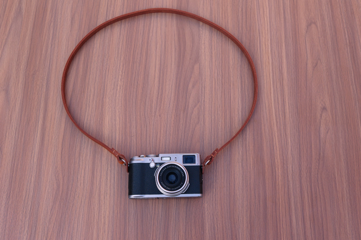 Detailed view of the leather finish on a handmade camera strap