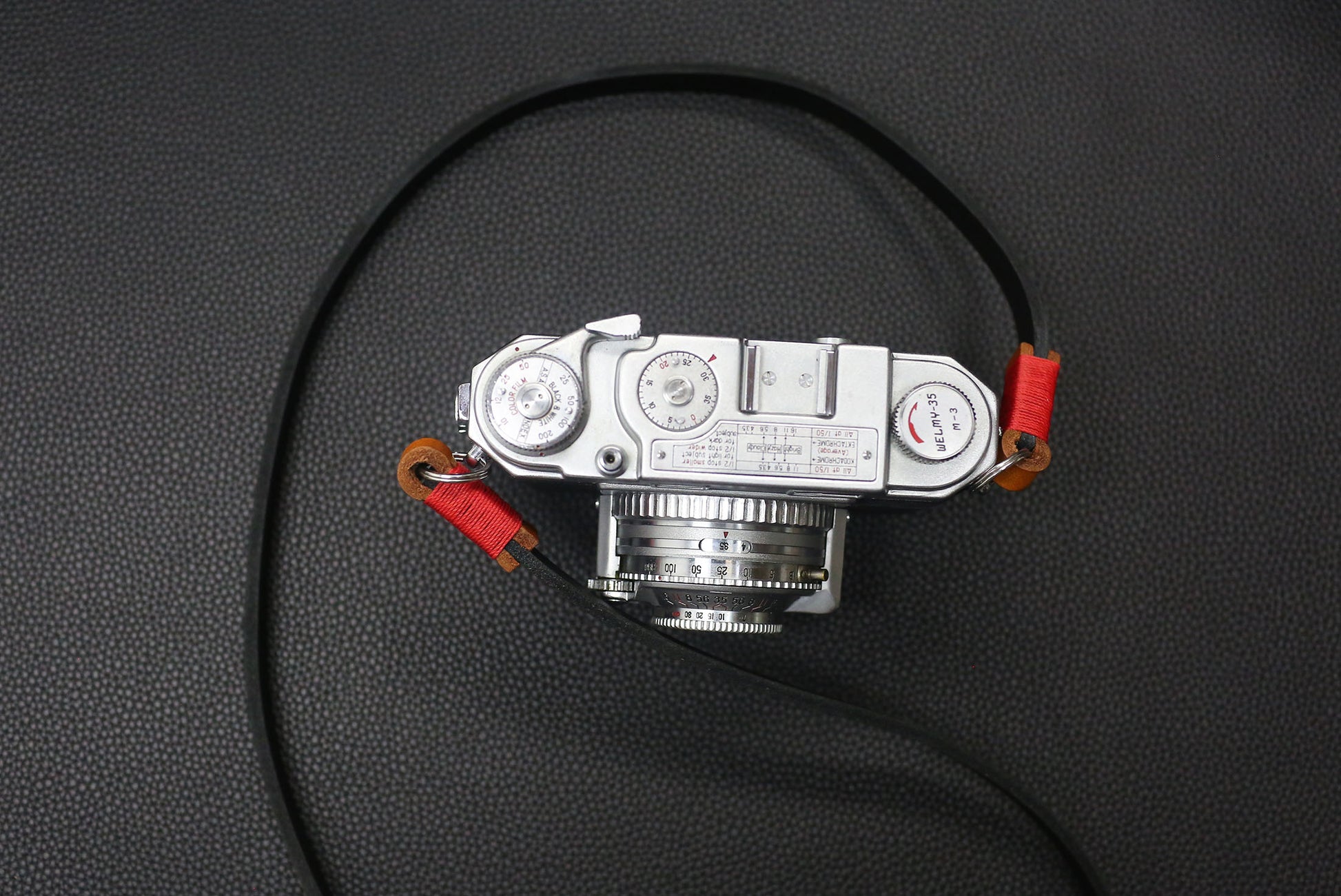 Detail view of leather loop and brass ring on Windmup camera strap.