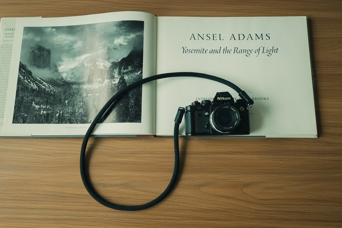 Minimalist all-black rope and leather camera strap