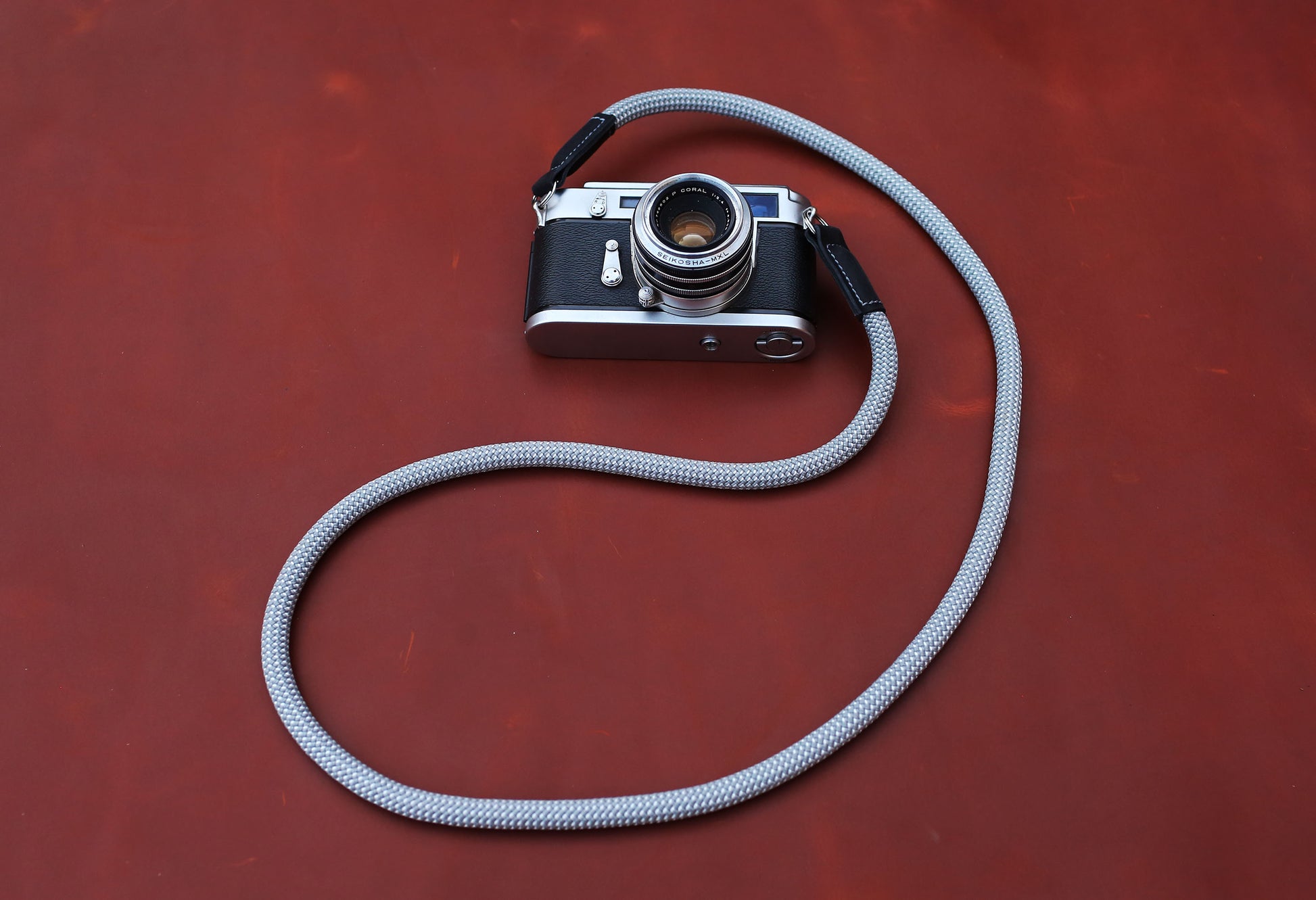 Minimalist camera accessories: Crimson and Ash grey rope straps with black leather.