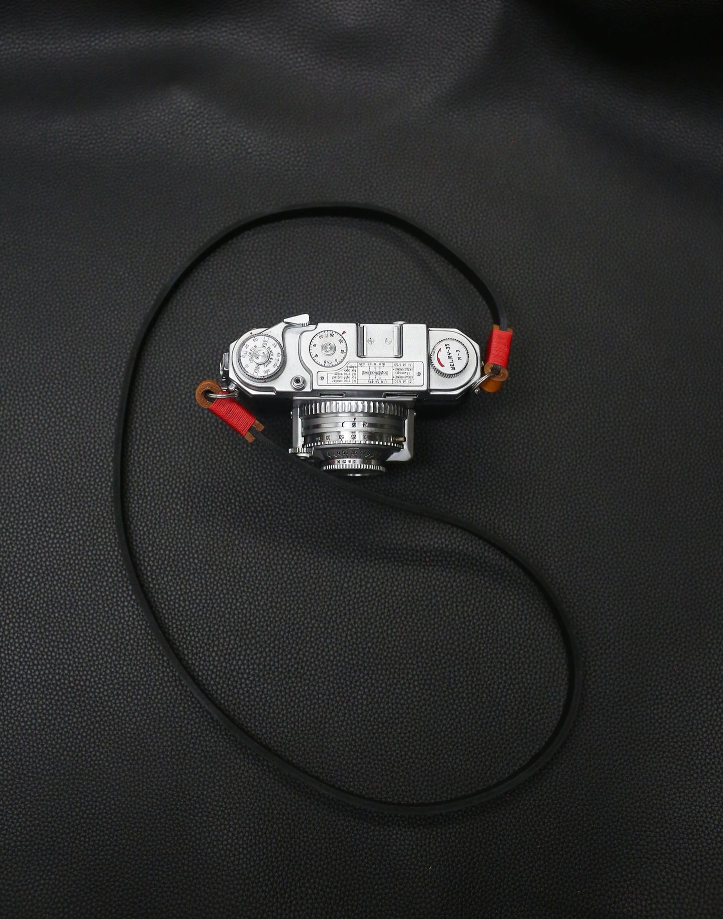 Windmup handcrafted camera strap, 95 cm black leather with brown connectors.