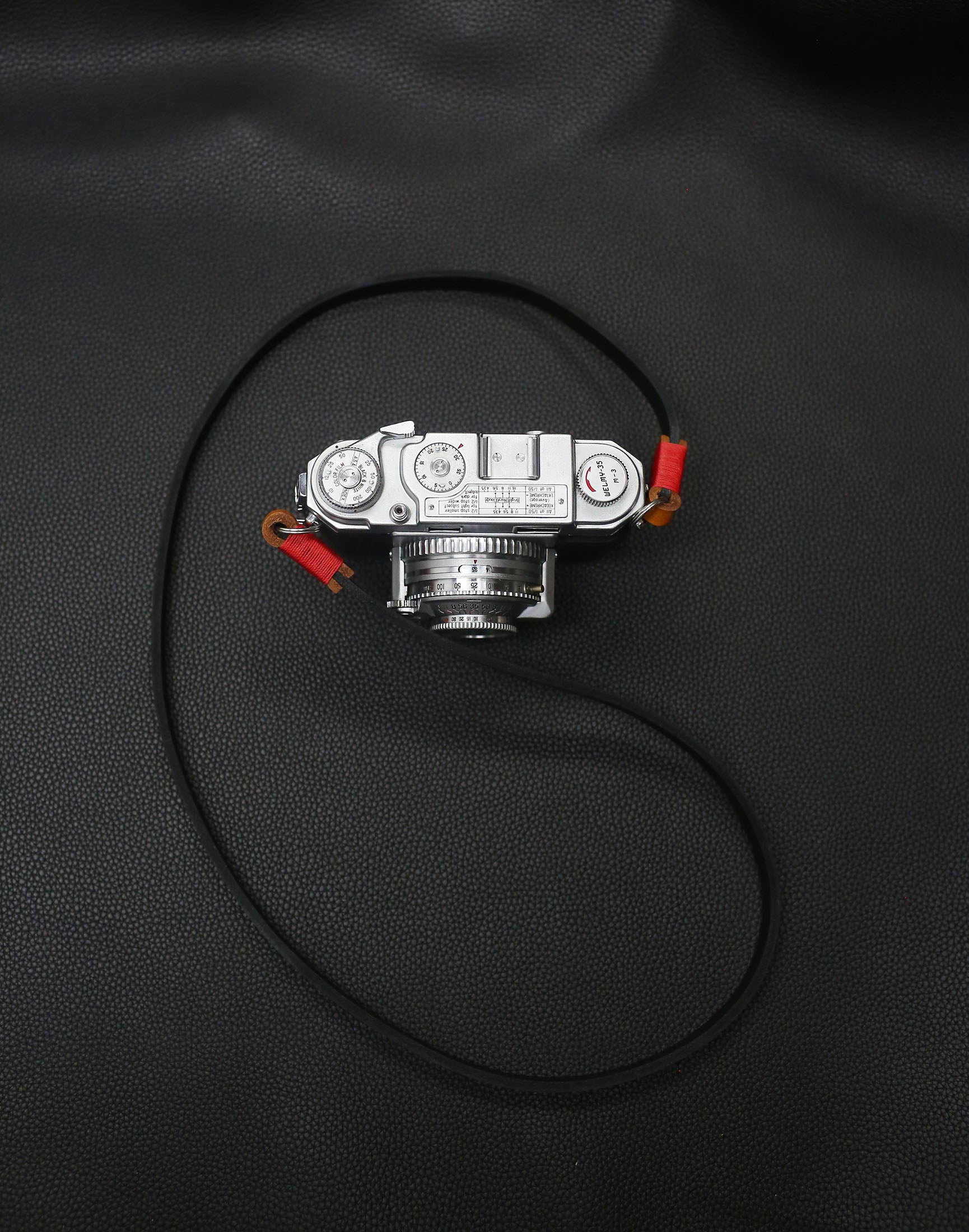 Windmup handcrafted camera strap, 95 cm black leather with brown connectors.