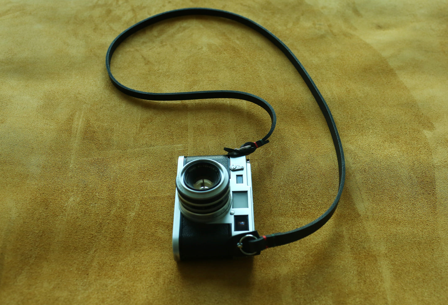 Minimalist matte black photography accessory sling for professional and film cameras