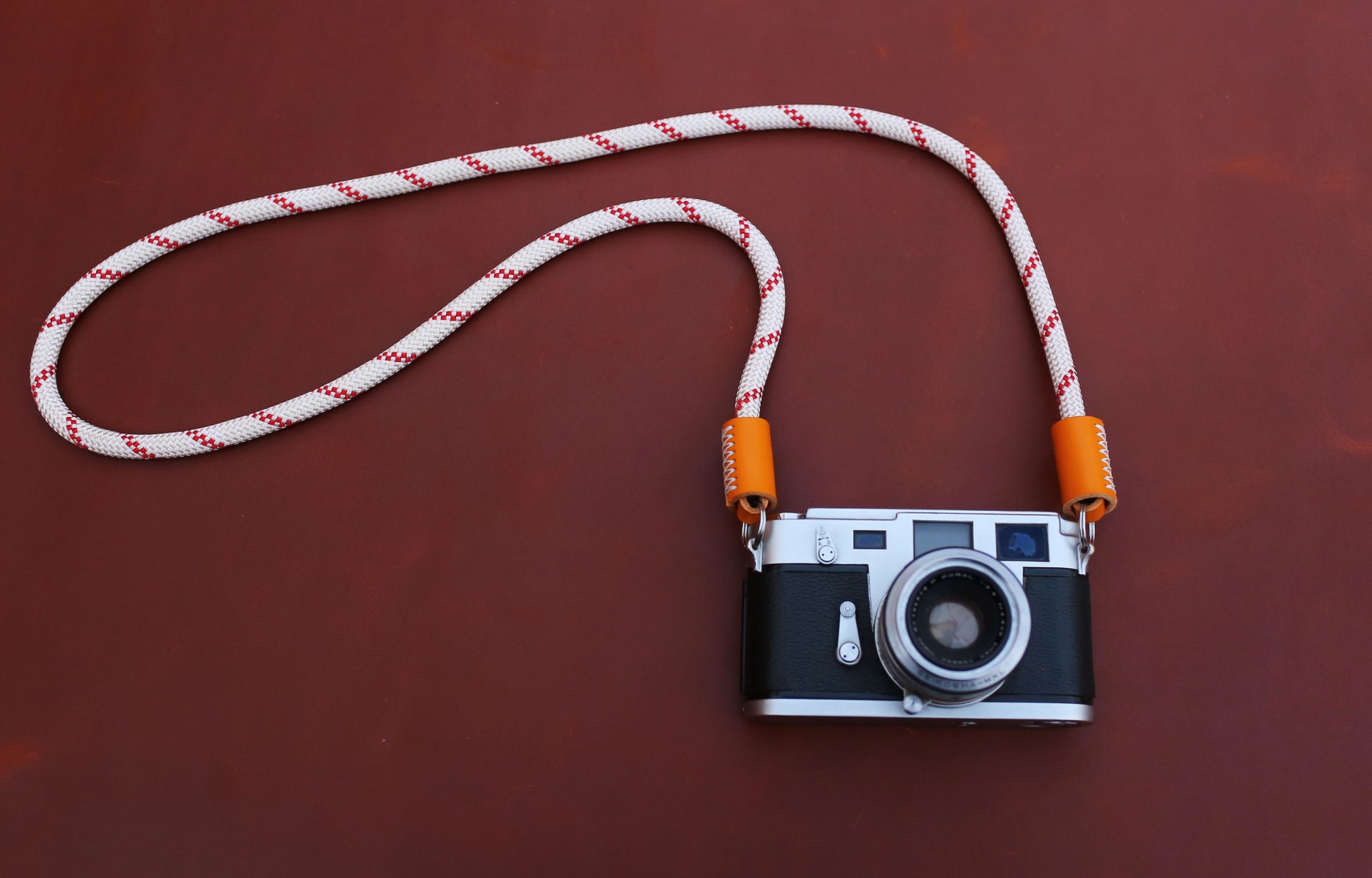 Minimalist white nylon climbing rope neck strap with red accents