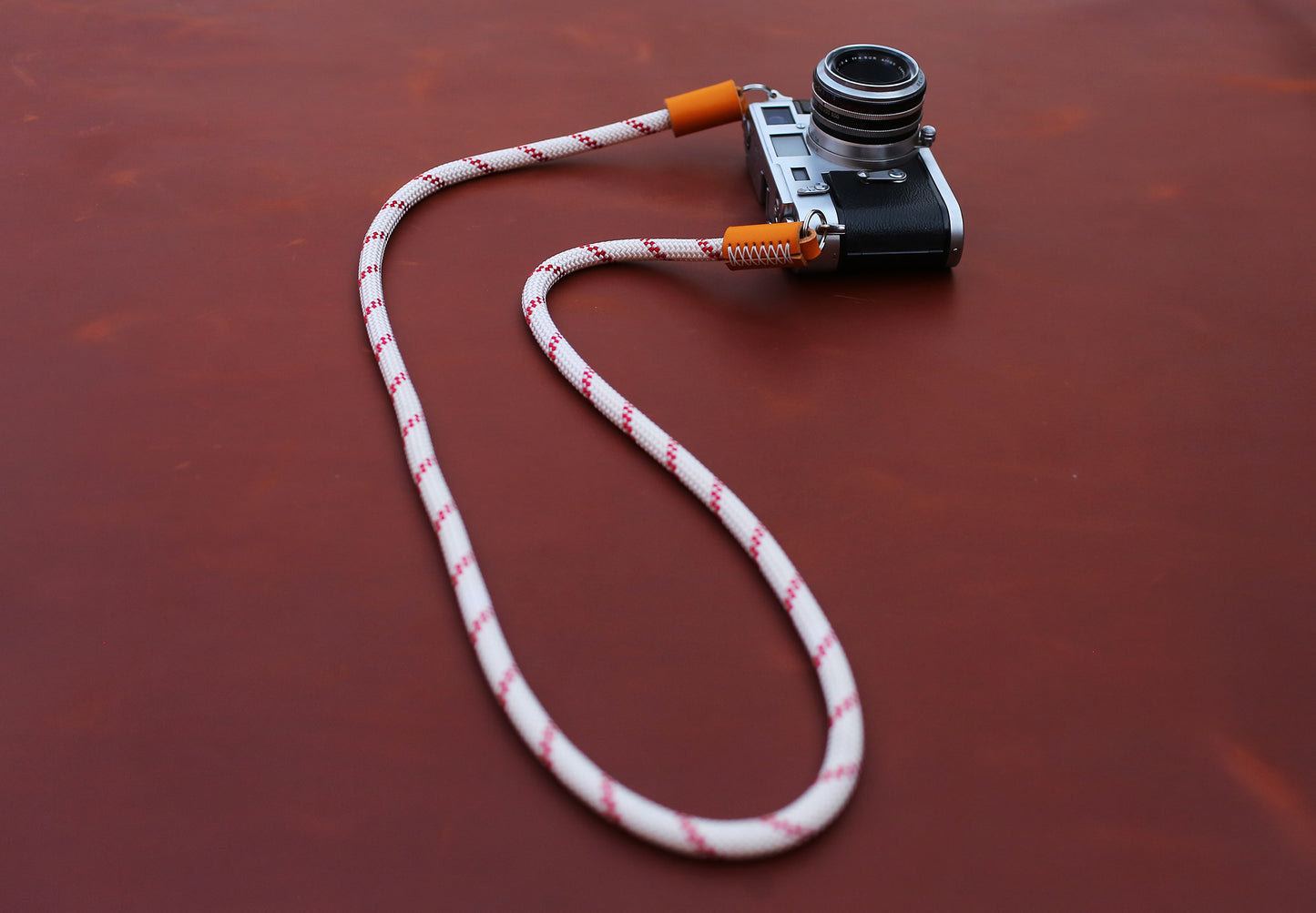 Close-up of 2.5mm orange vegetable-tanned leather and hand-stitching