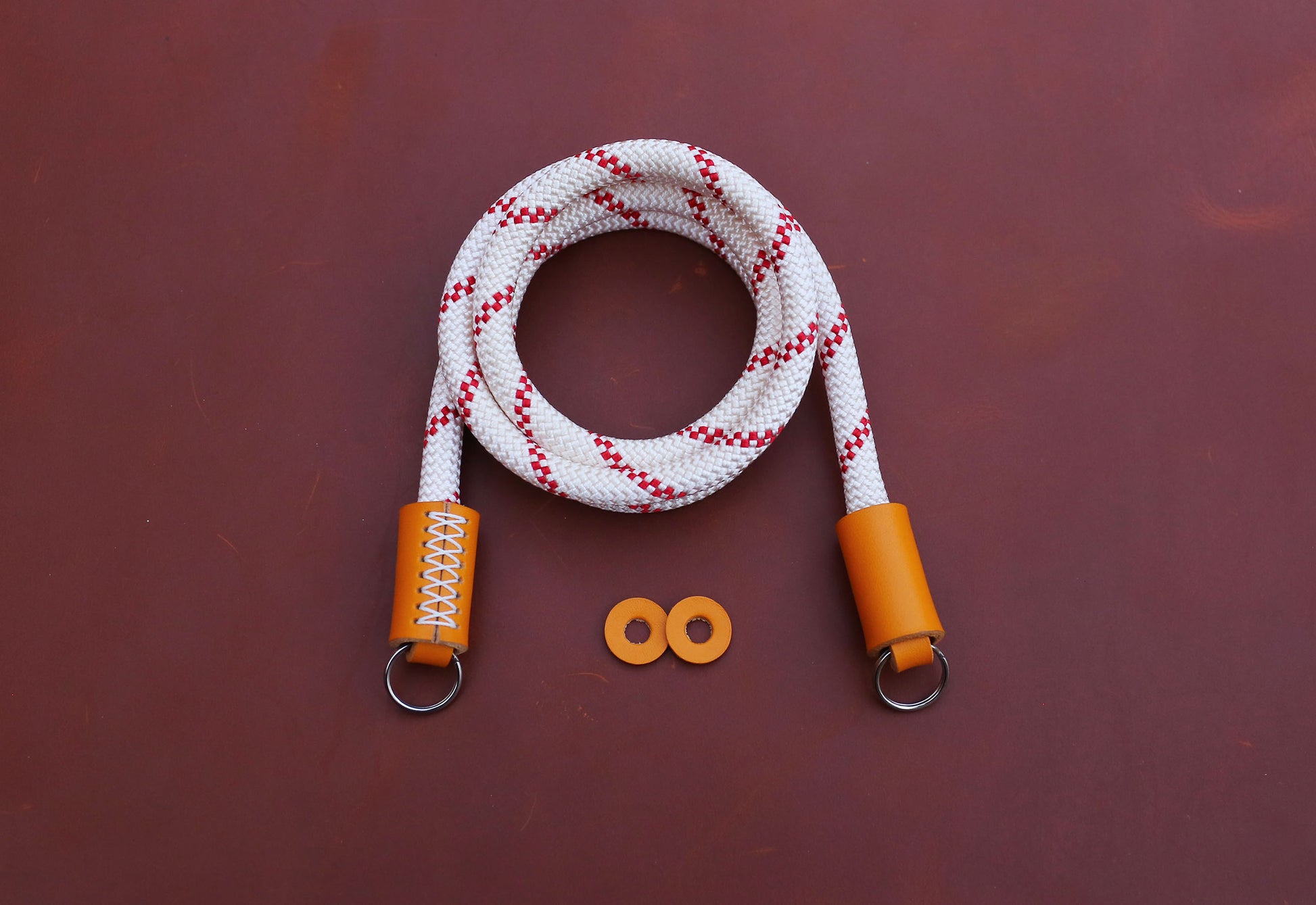 Premium orange leather accents on handmade camera accessories