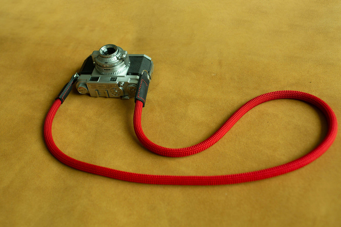 Red climbing rope camera strap designed for Leica, Fujifilm, and Sony mirrorless systems