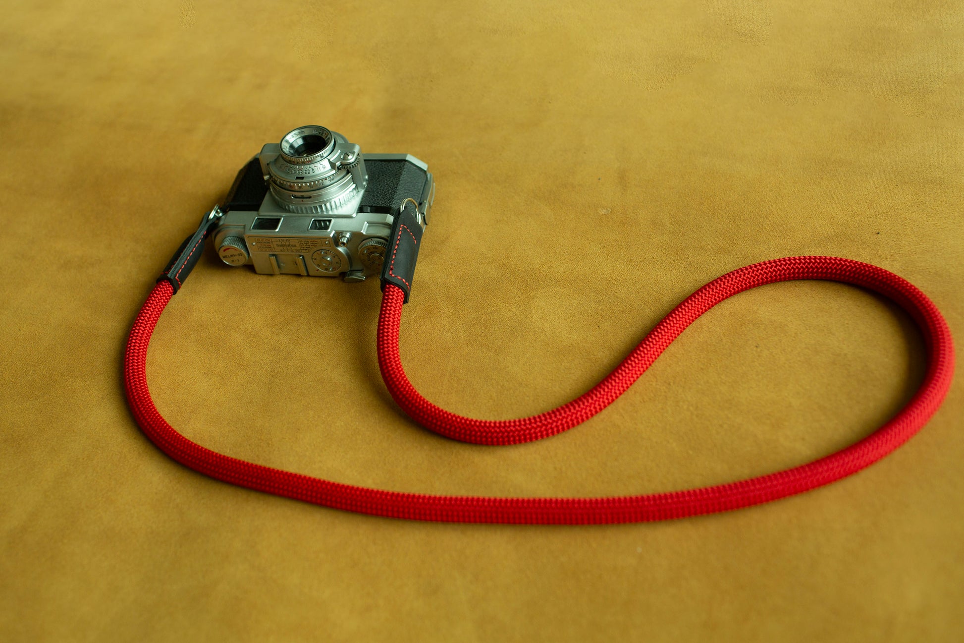 Red climbing rope camera strap designed for Leica, Fujifilm, and Sony mirrorless systems