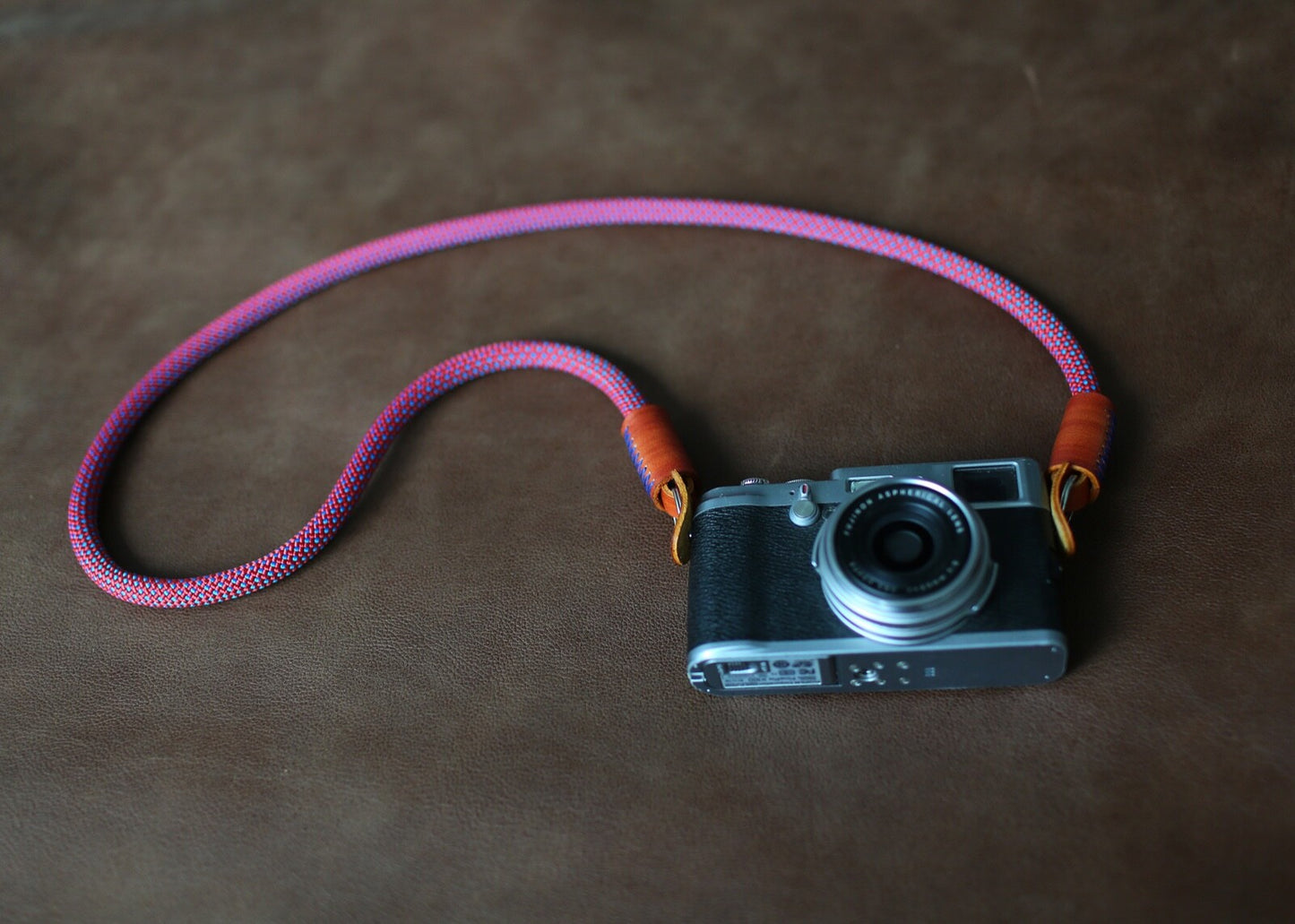 rope camera strap laid beside vintage camera