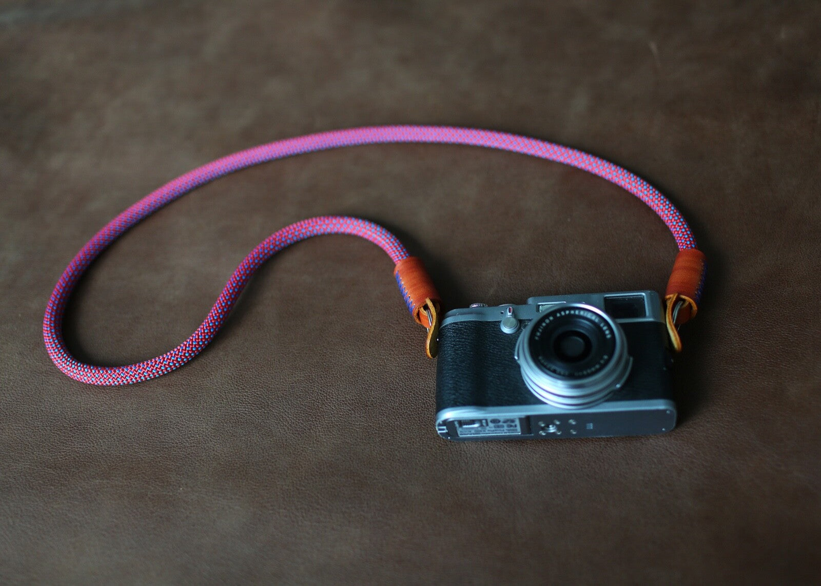 rope camera strap laid beside vintage camera