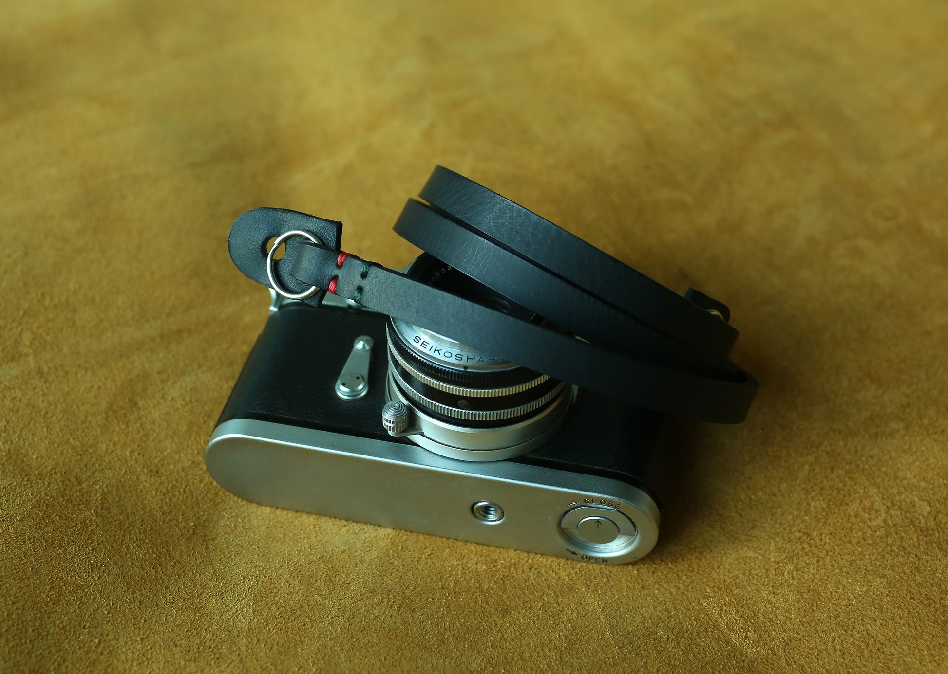 Tactile and comfortable thick leather camera carrier in classic black hide