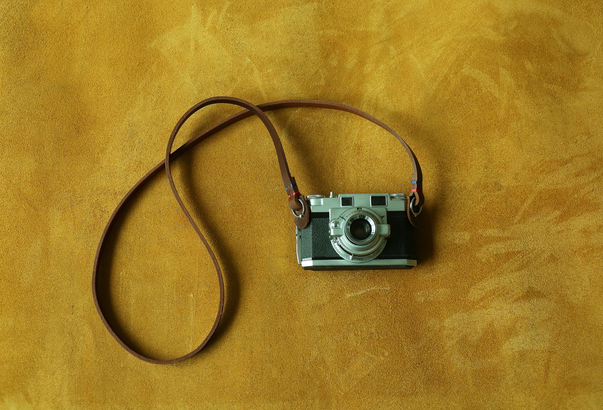 Tan brown leather strap compatible with mirrorless camera systems