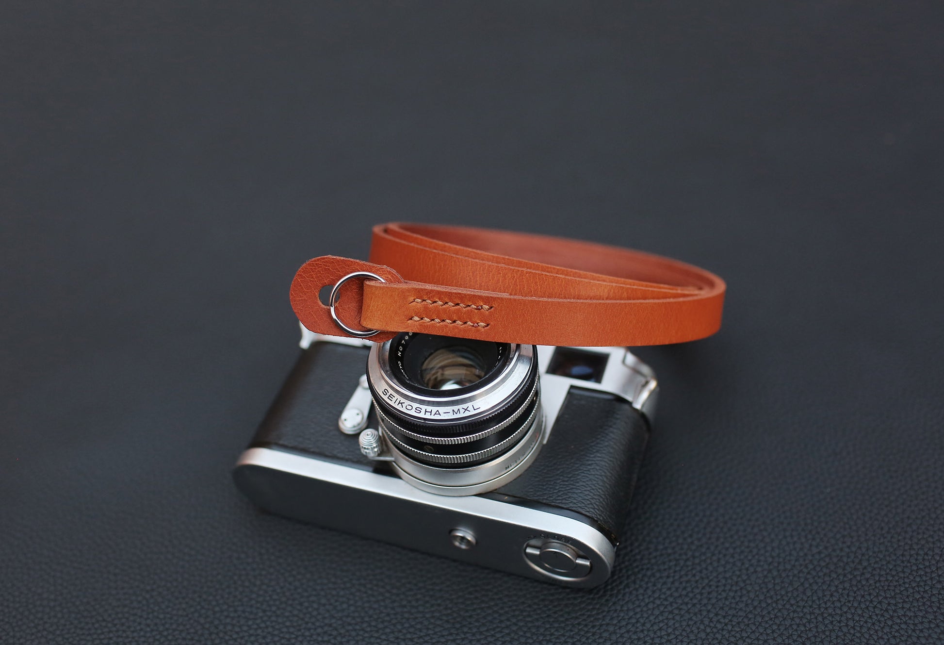 Close-up of stitching on tan camera strap