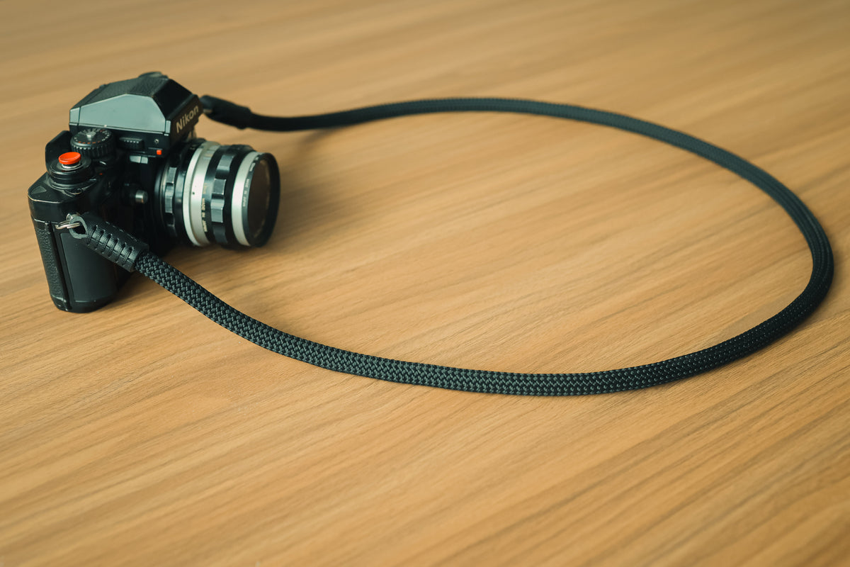 The Stealth black camera strap attached to a mirrorless camera