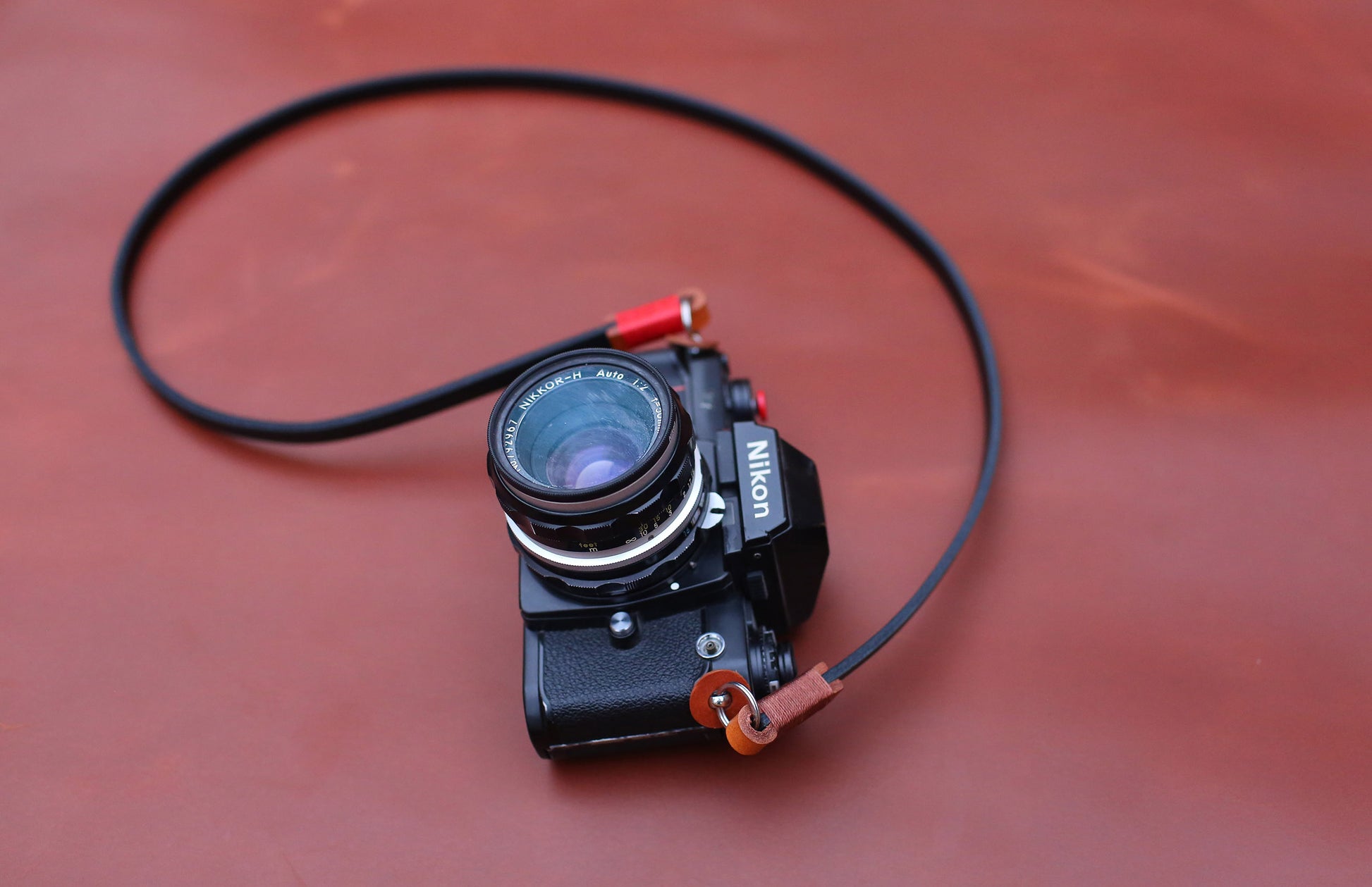 Brown leather tab and red wax thread detail