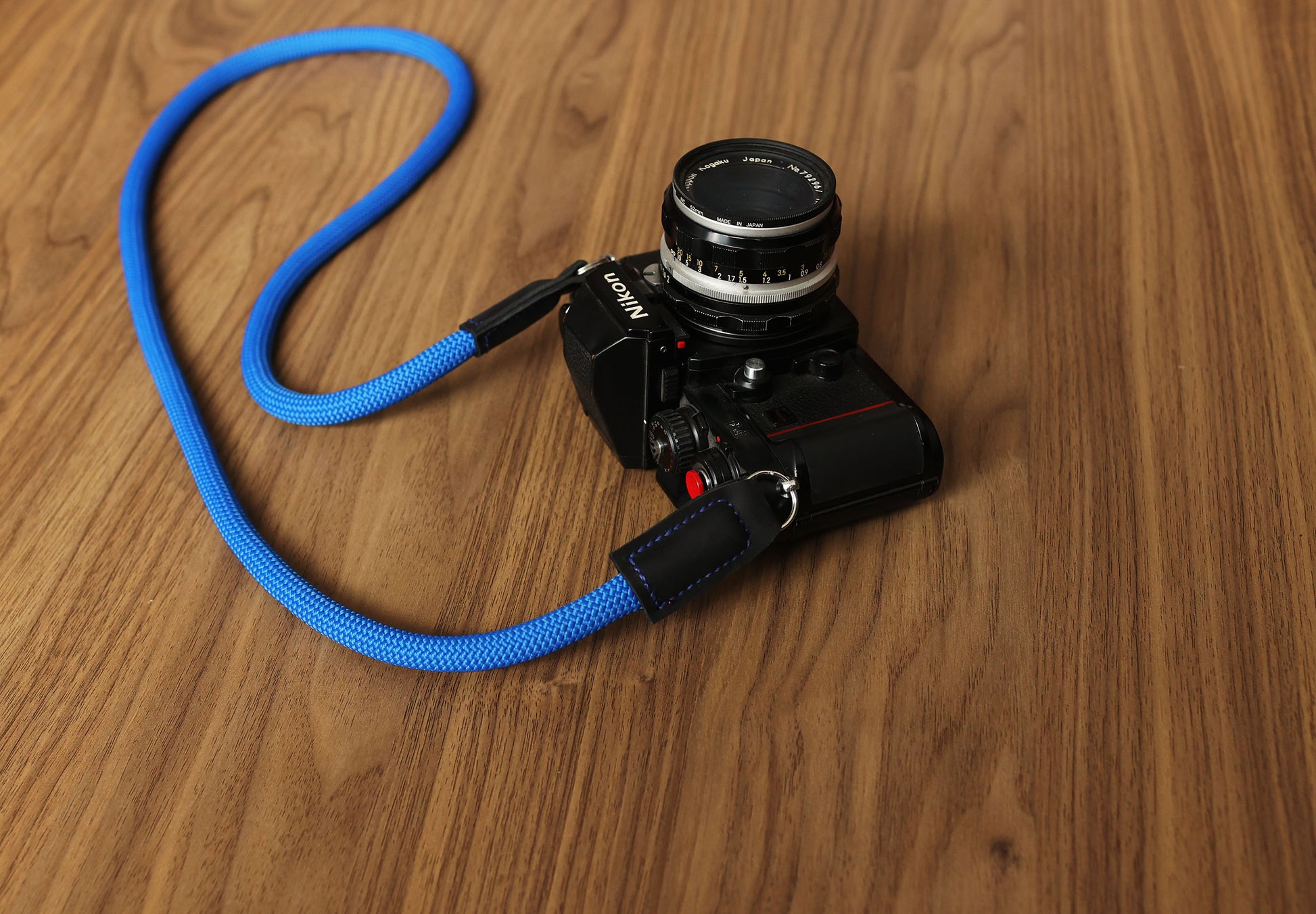 Blue rope camera strap attached to a vintage camera