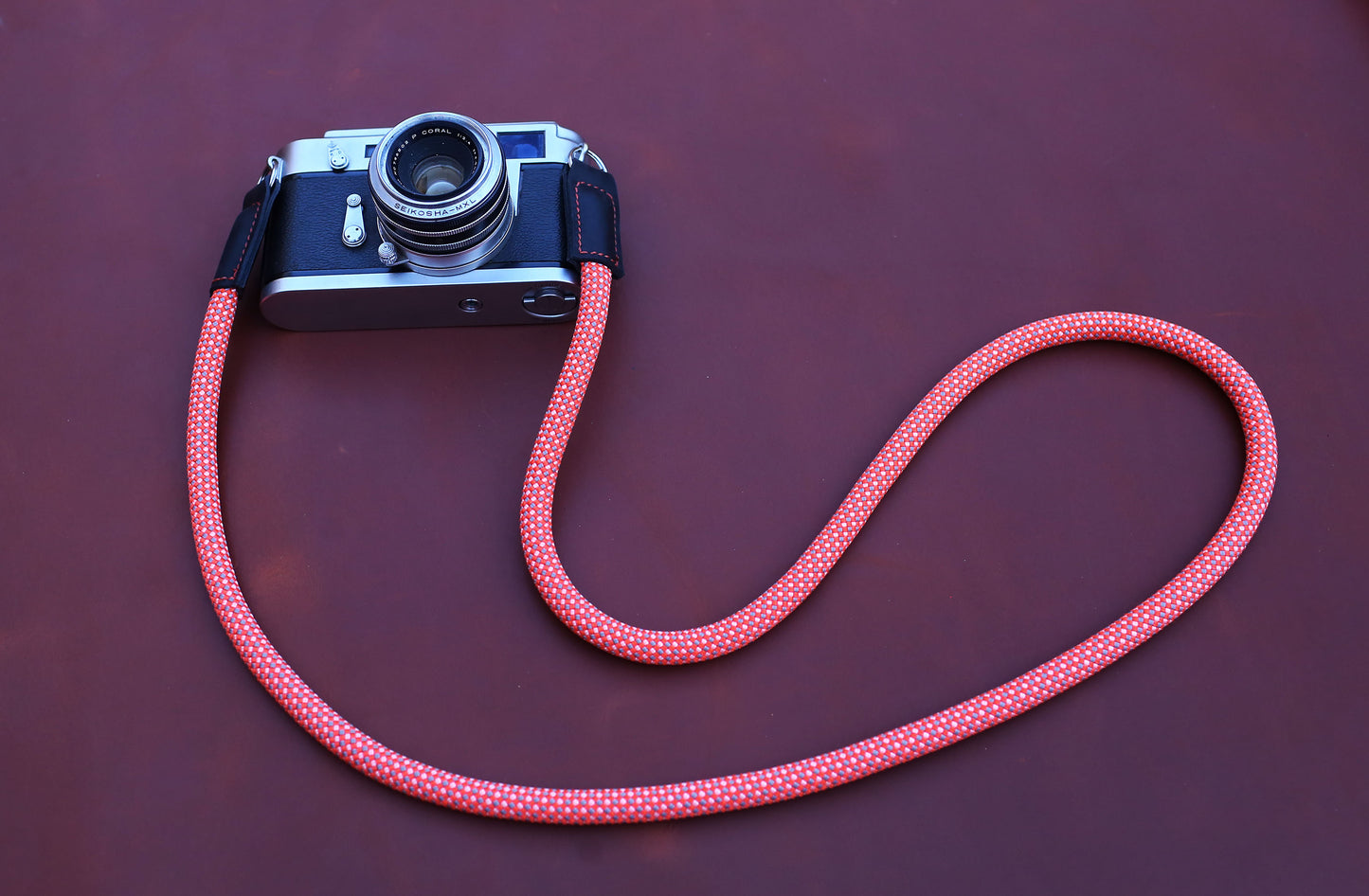 rope-strap.jpg	Classic 35mm film camera paired with a vibrant red spotted rope strap