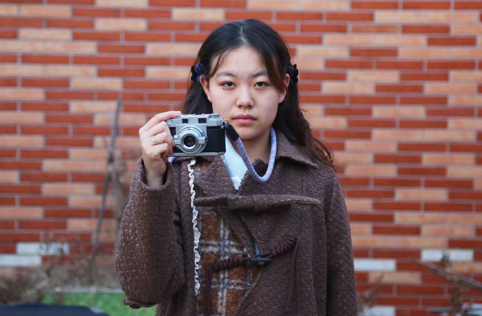 Violet elastic camera strap paired with a vintage style camera