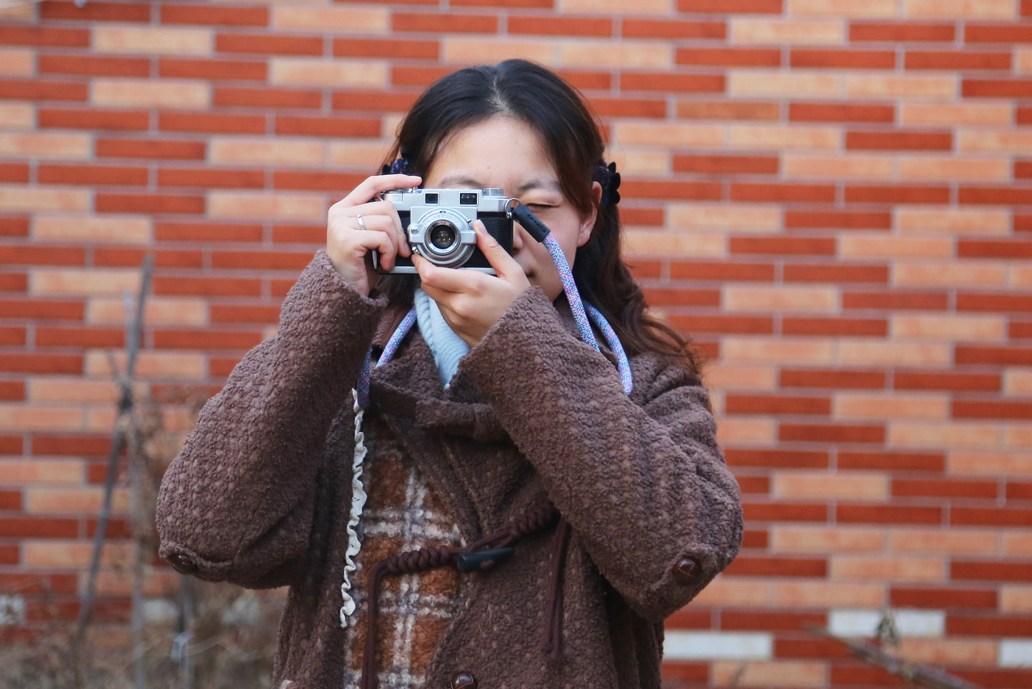 Violet elastic camera strap with soft woven texture laid flat