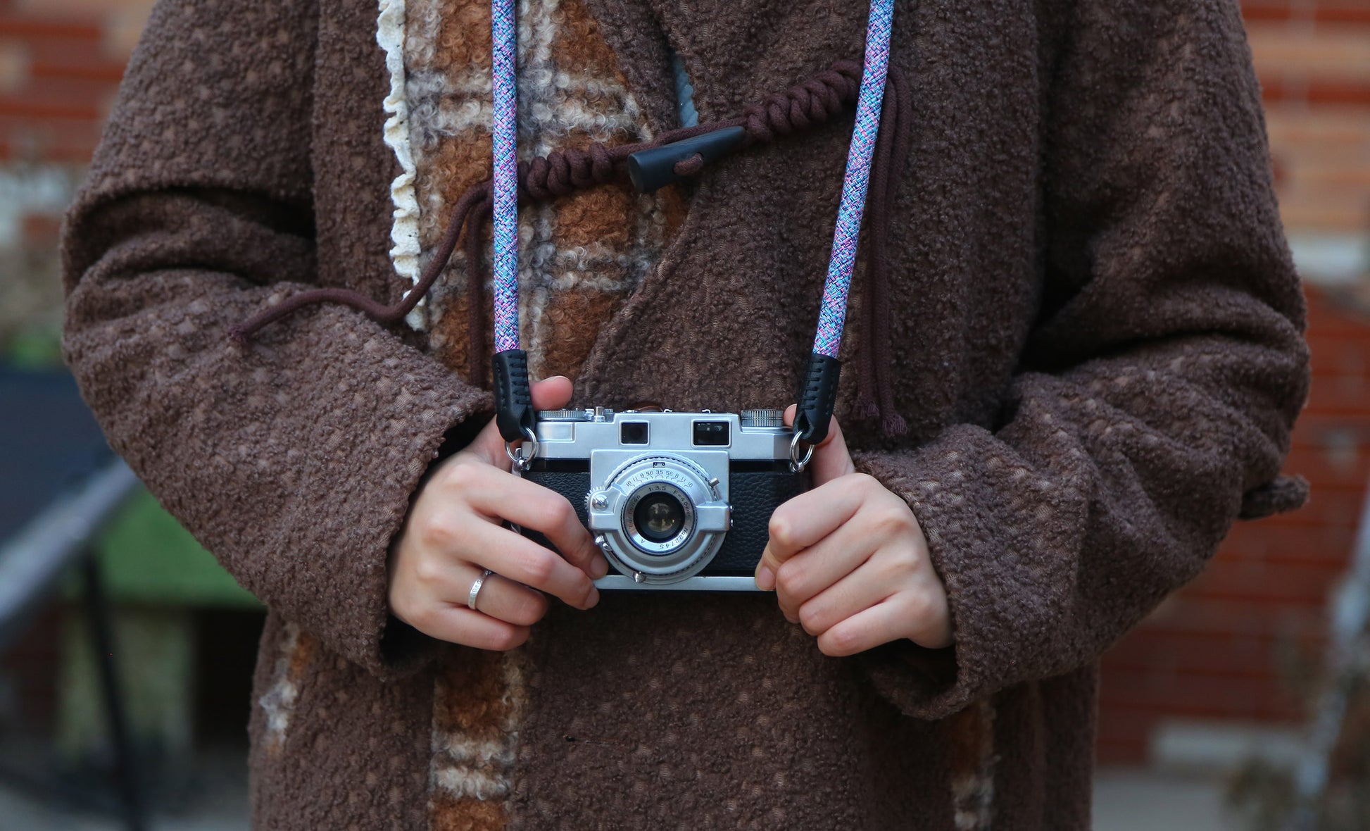 Close-up of violet elastic woven camera strap showing soft stretch texture