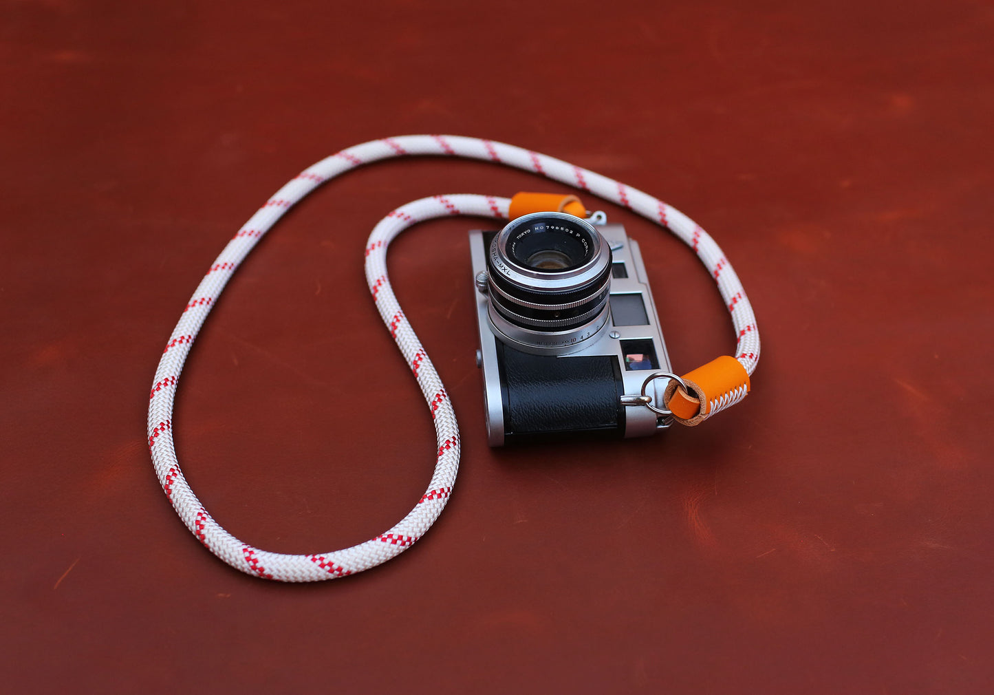 White and red rope strap featuring protective leather O-rings