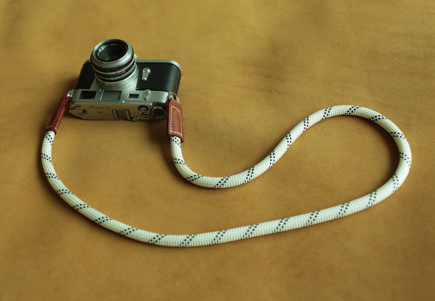White rope camera strap compatible with Leica, Fujifilm, and Sony