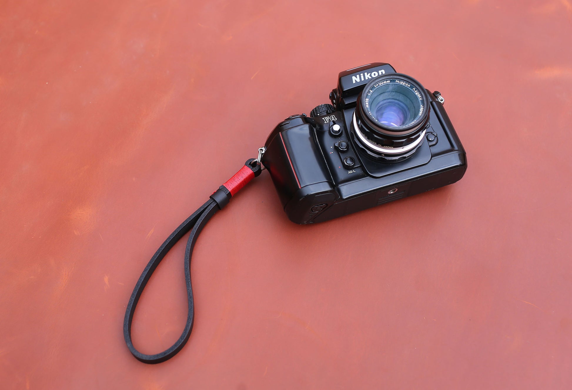 Handcrafted 3.5mm buffalo leather camera wrist strap with red waxed stitching