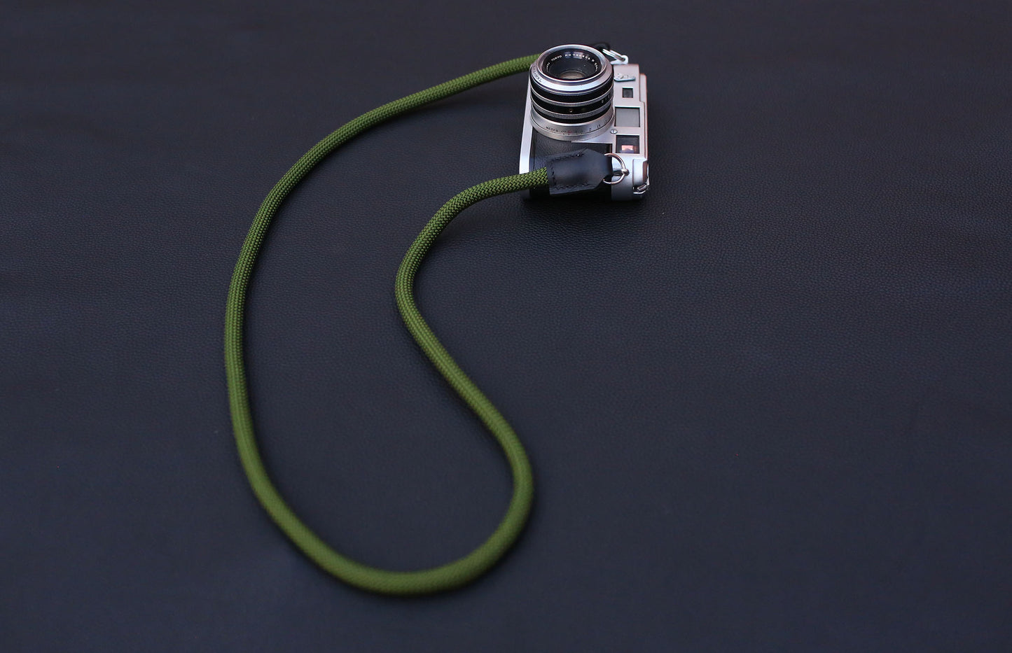 army green rope strap detail shot showing stitching