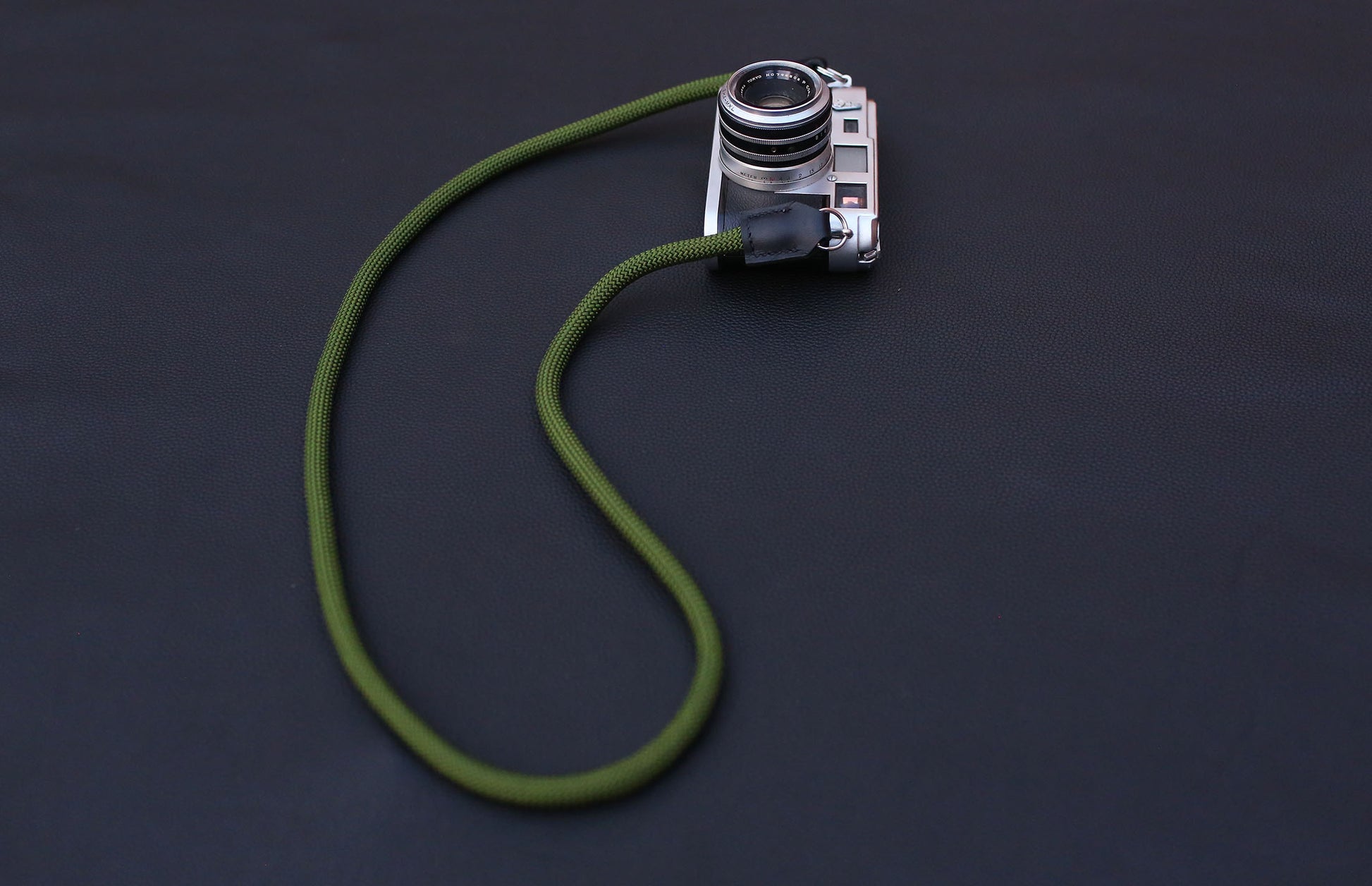 army green rope strap detail shot showing stitching