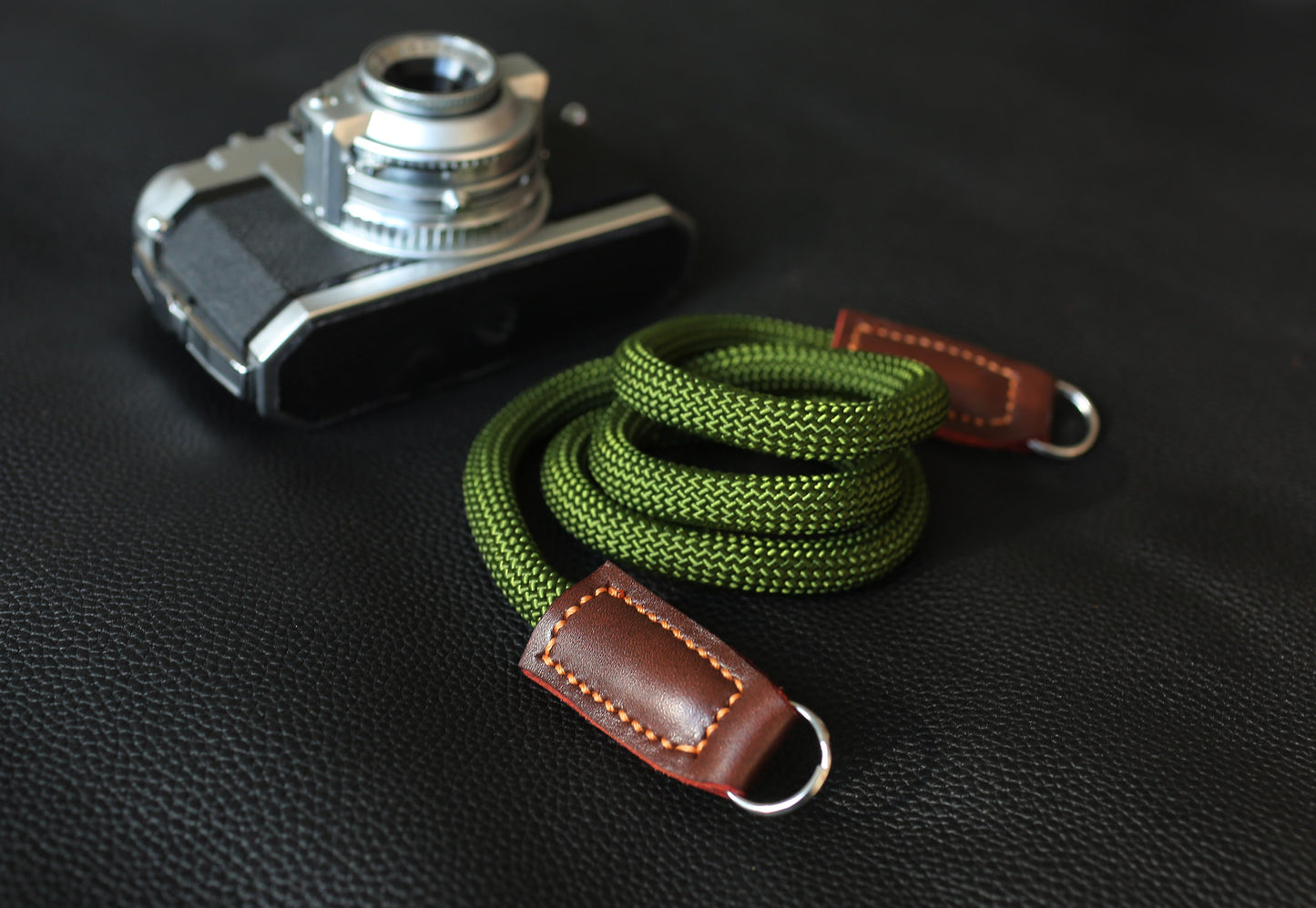 green rope strap with brown leather