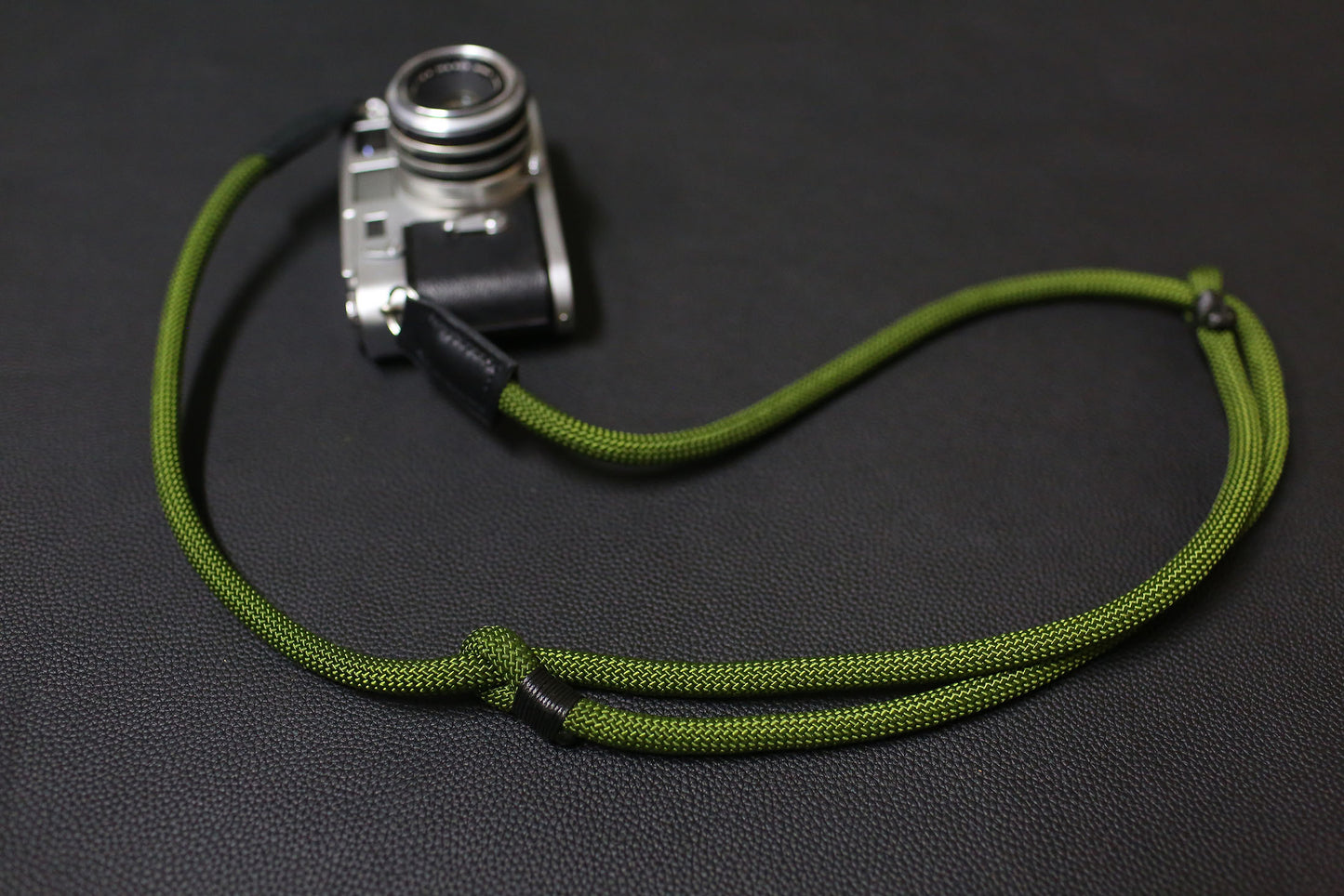 Hand-stitched leather connectors on Windmup camera strap