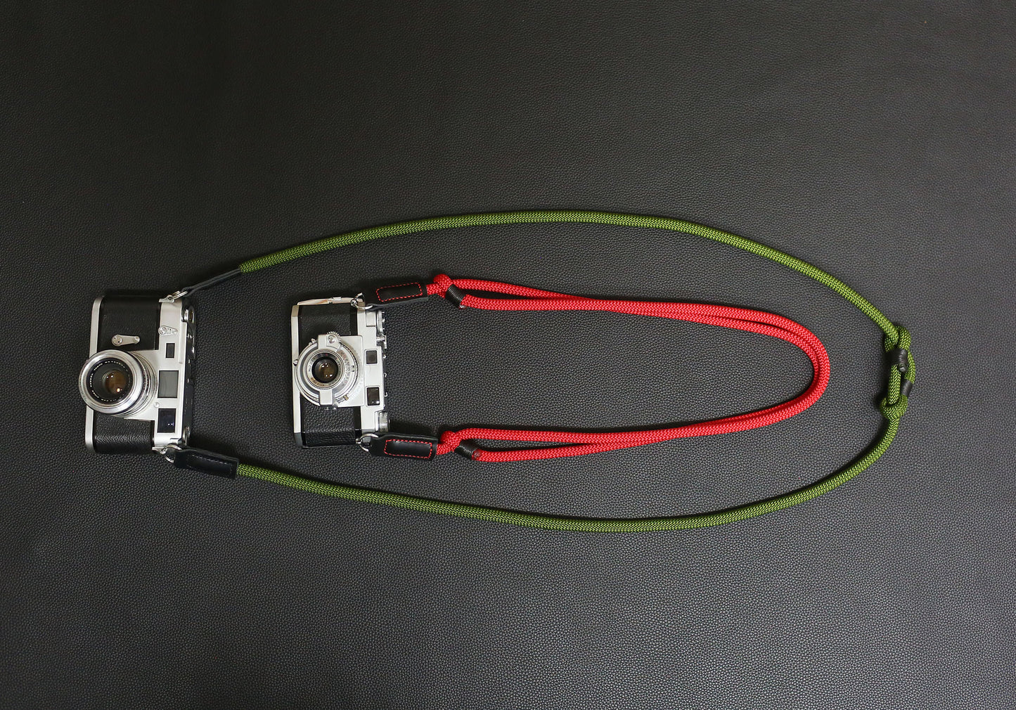 Red and green rope straps on vintage film cameras