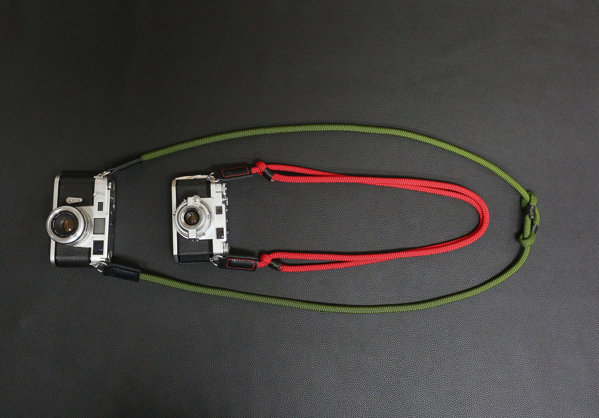 Red and green rope straps on vintage film cameras