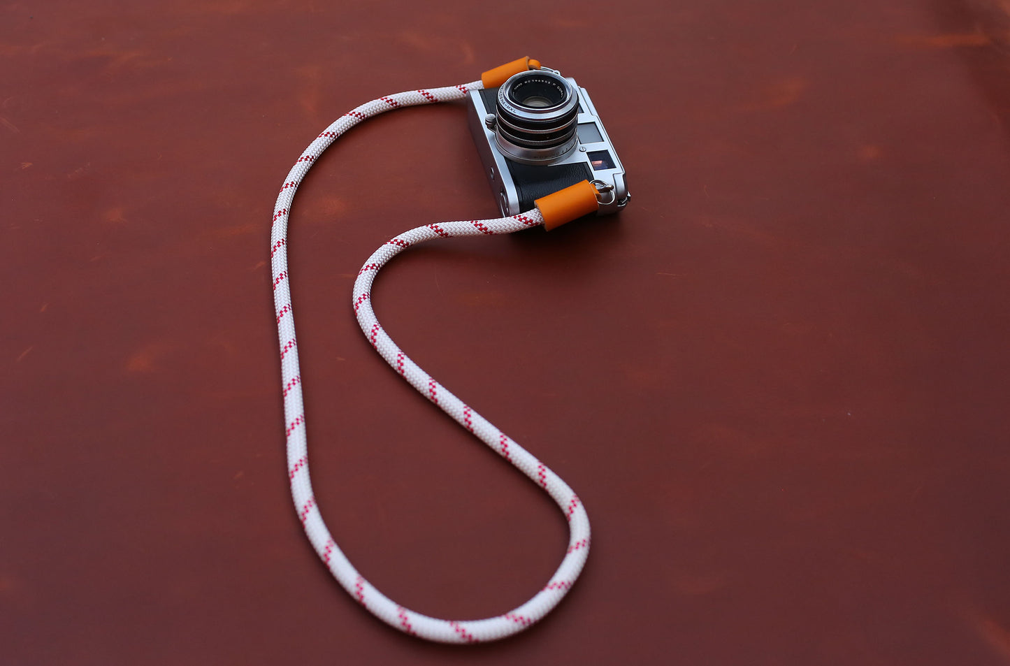 Artisan climbing rope camera strap in white and red with orange leather