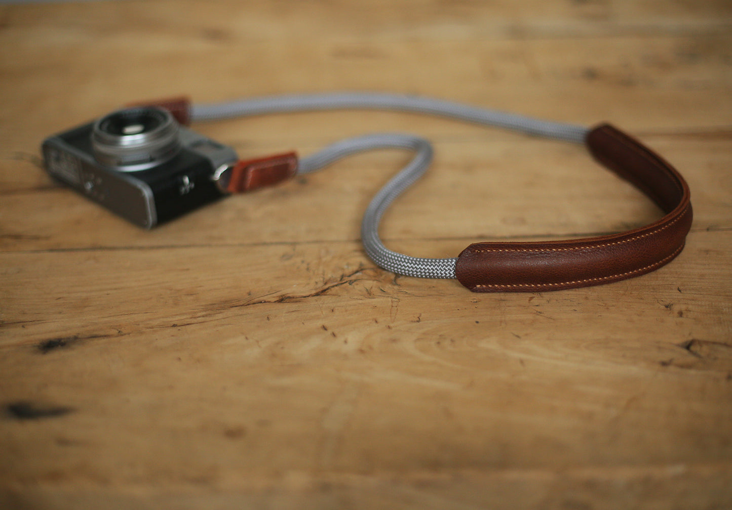 Detail of hand-stitched brown leather pad and metal ring