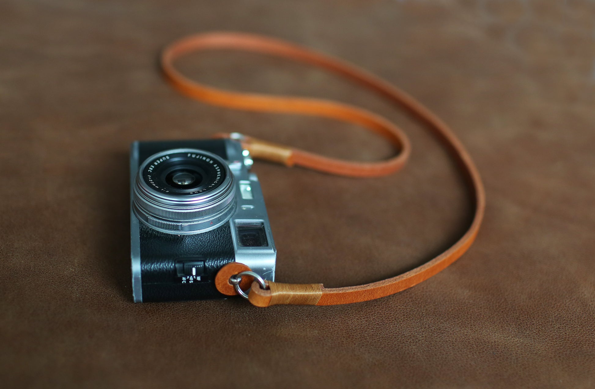 Minimalist brown leather camera strap for street and travel photography