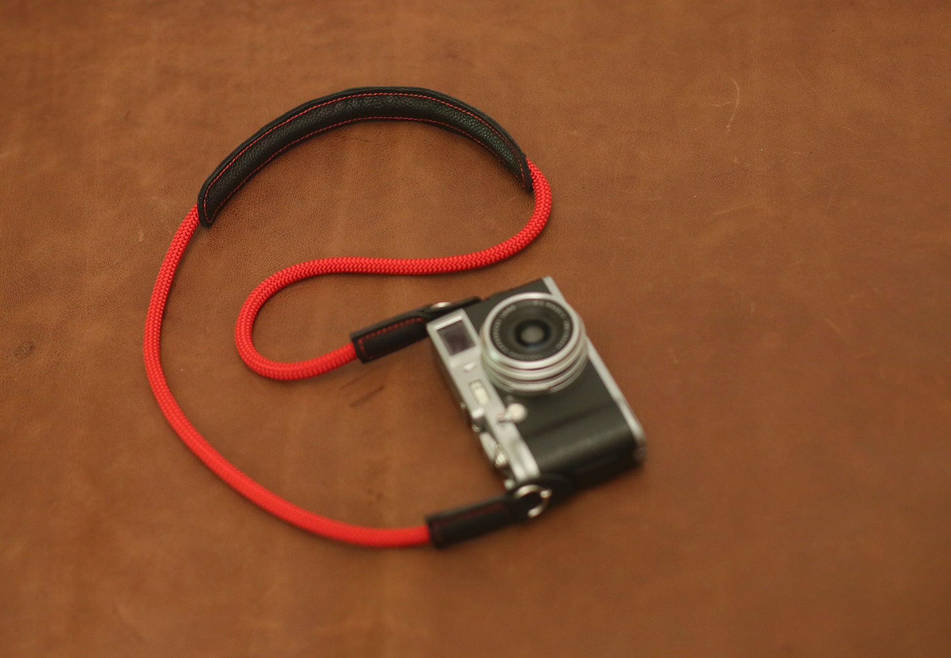 Red and black camera neck strap with shoulder support