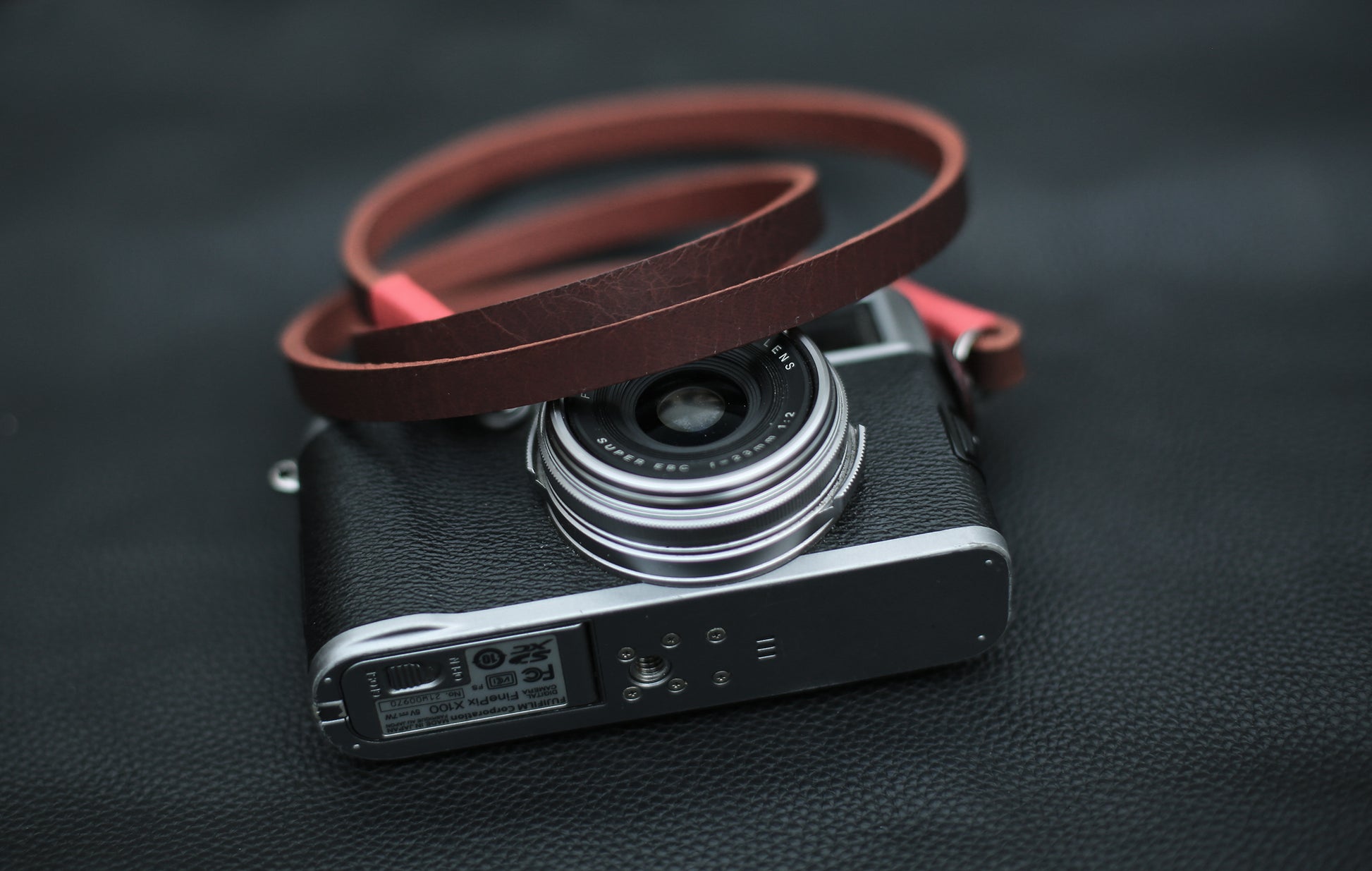 Minimalist brown camera strap with black leather accents