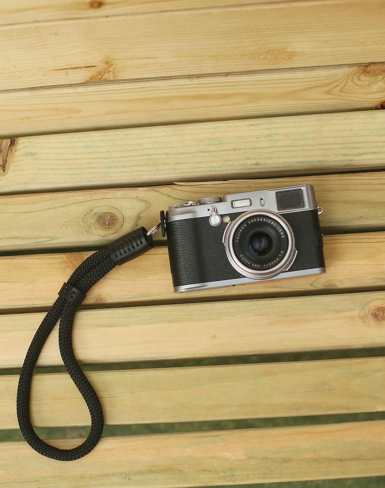 Compact black wrist strap loop for mirrorless camera