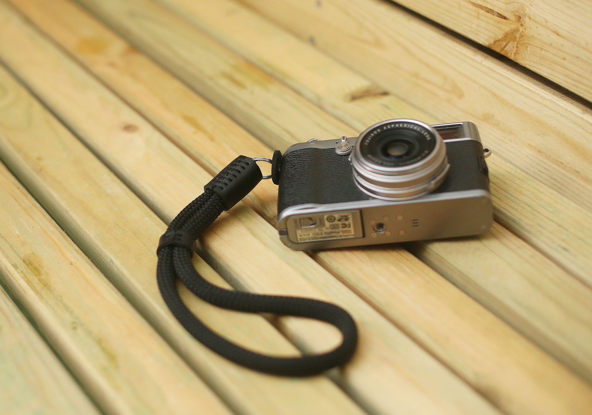 Hand-stitched leather endcap on black camera strap