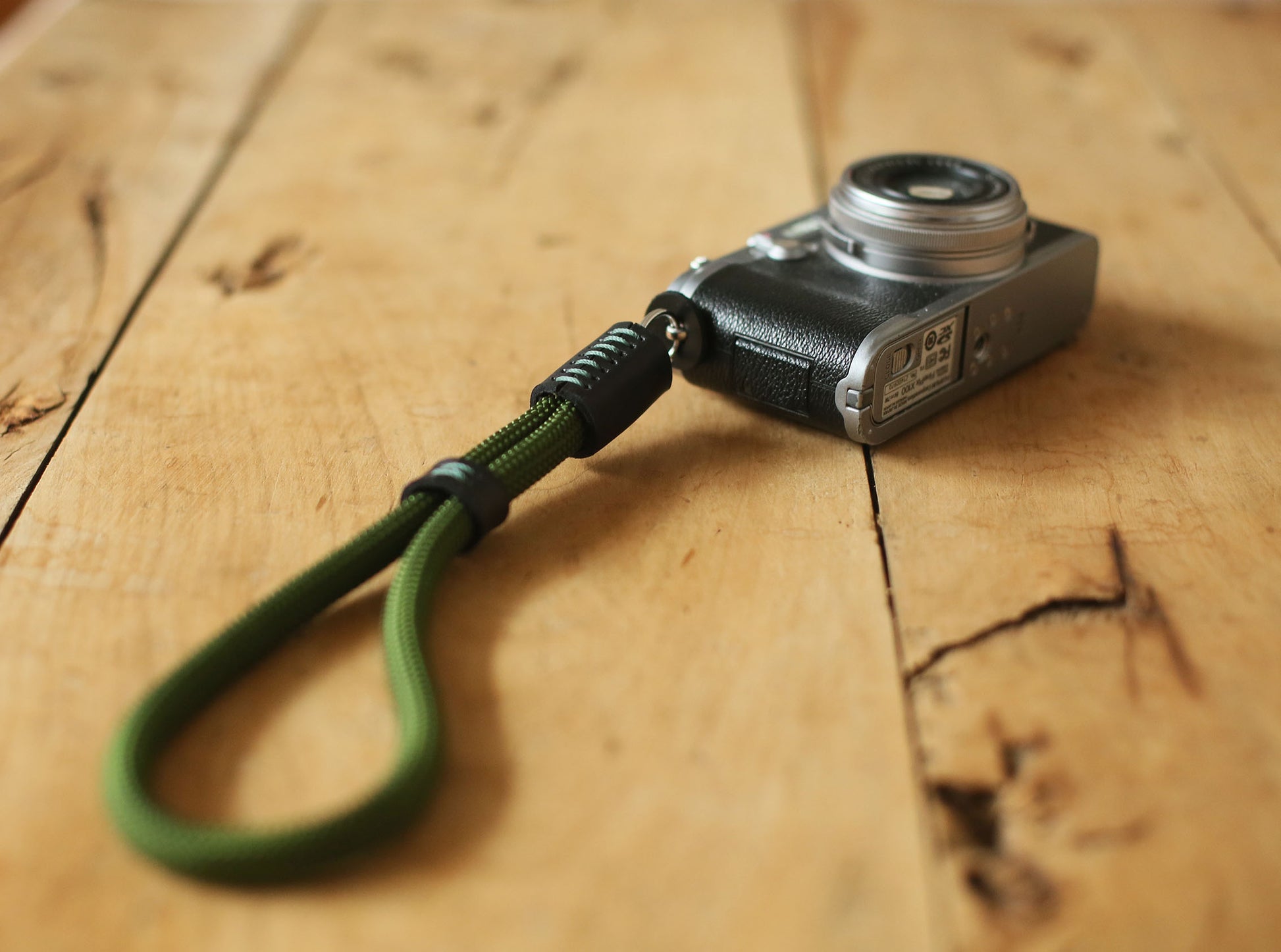 Black leather and green stitched wrist strap for cameras