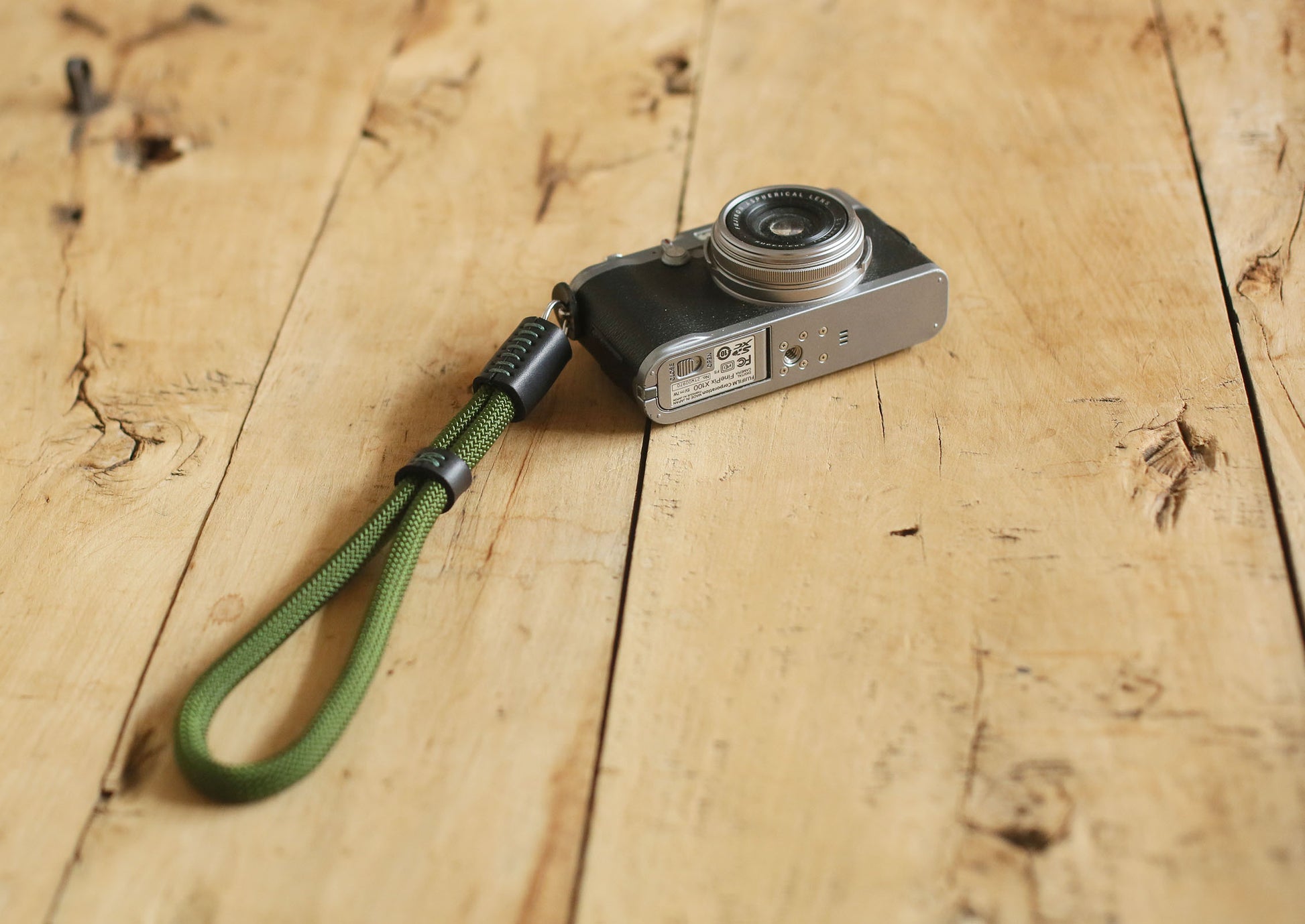 Green climbing rope strap with black leather ends