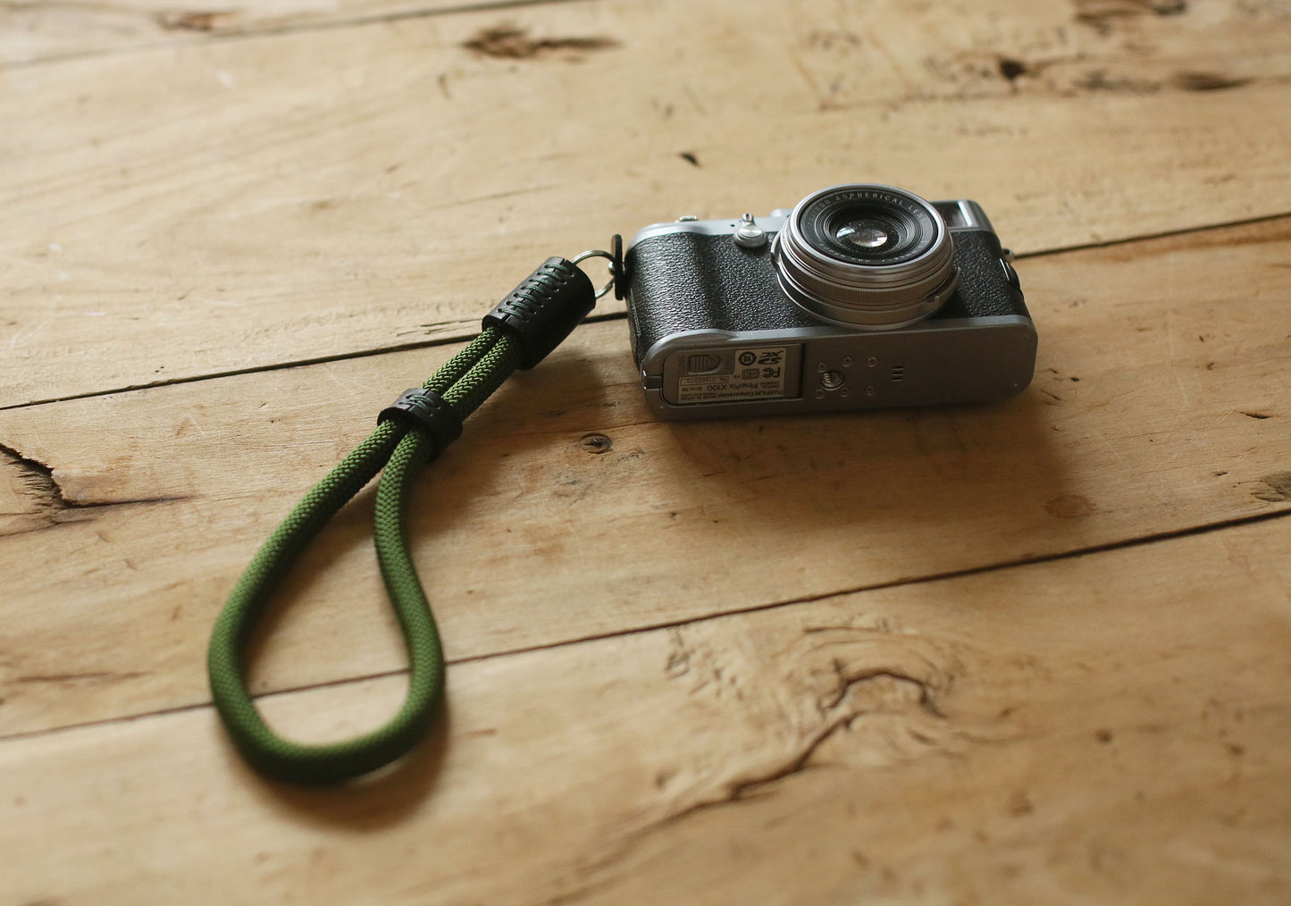 Black leather detail on military green camera wrist strap