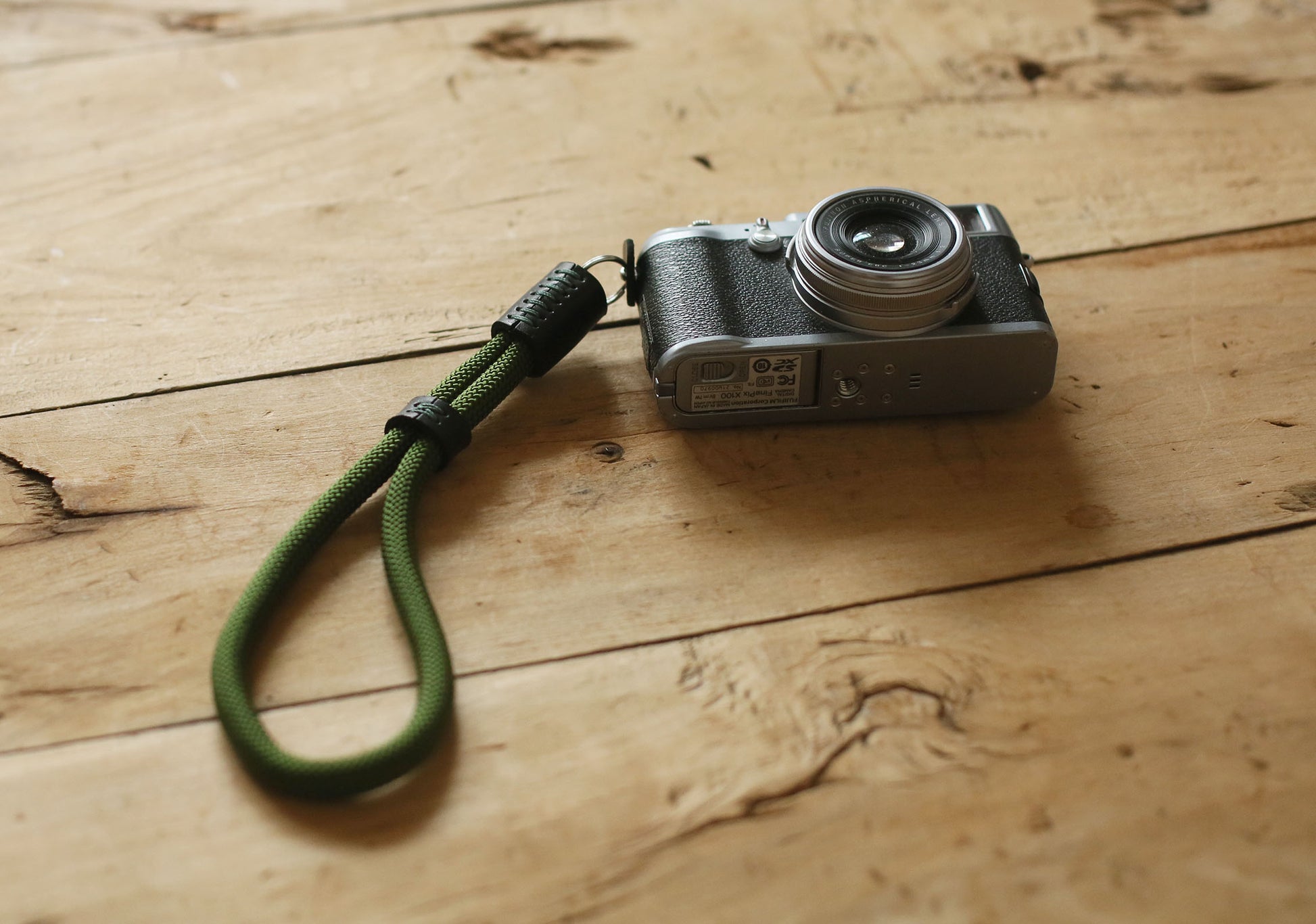 Black leather detail on military green camera wrist strap