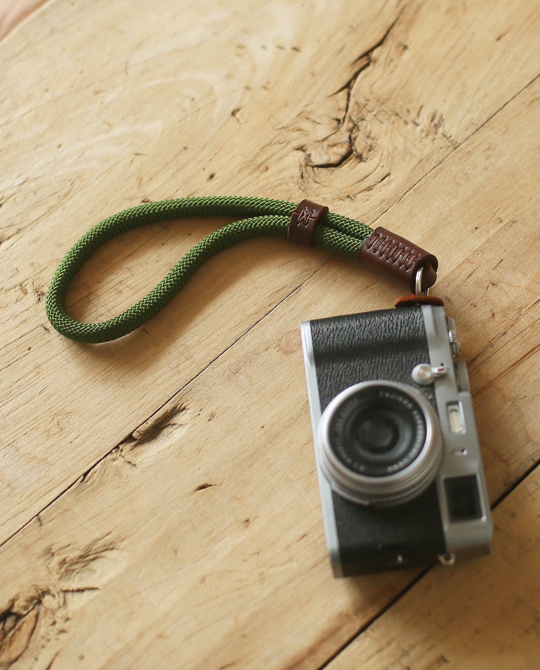 Minimalist green and tan leather wrist strap for compact cameras