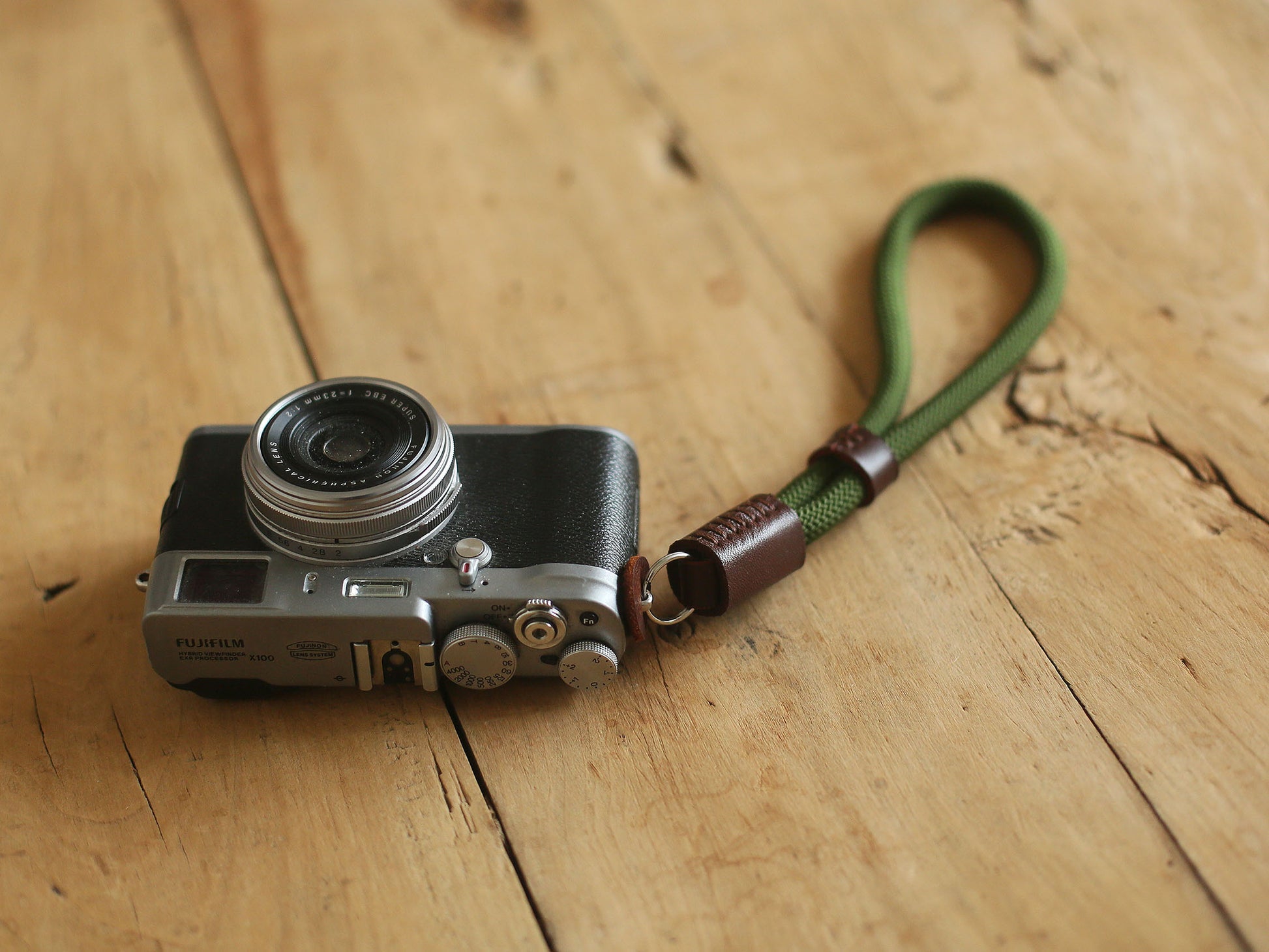 Windmup army green wrist strap on hand with camera