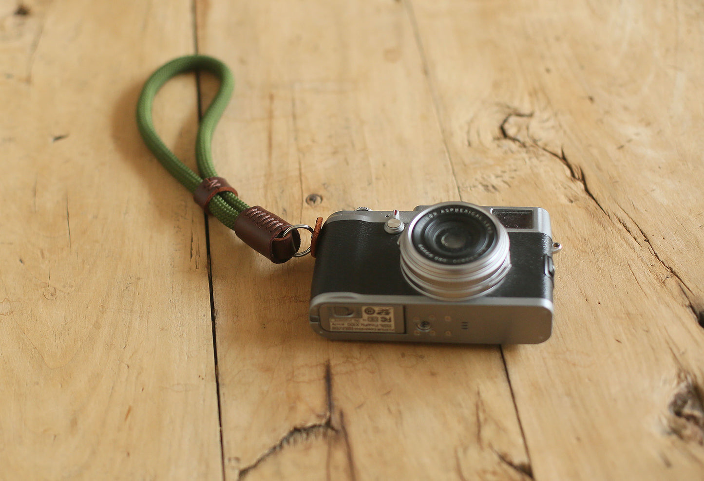 Close-up of tan leather accent on green rope strap